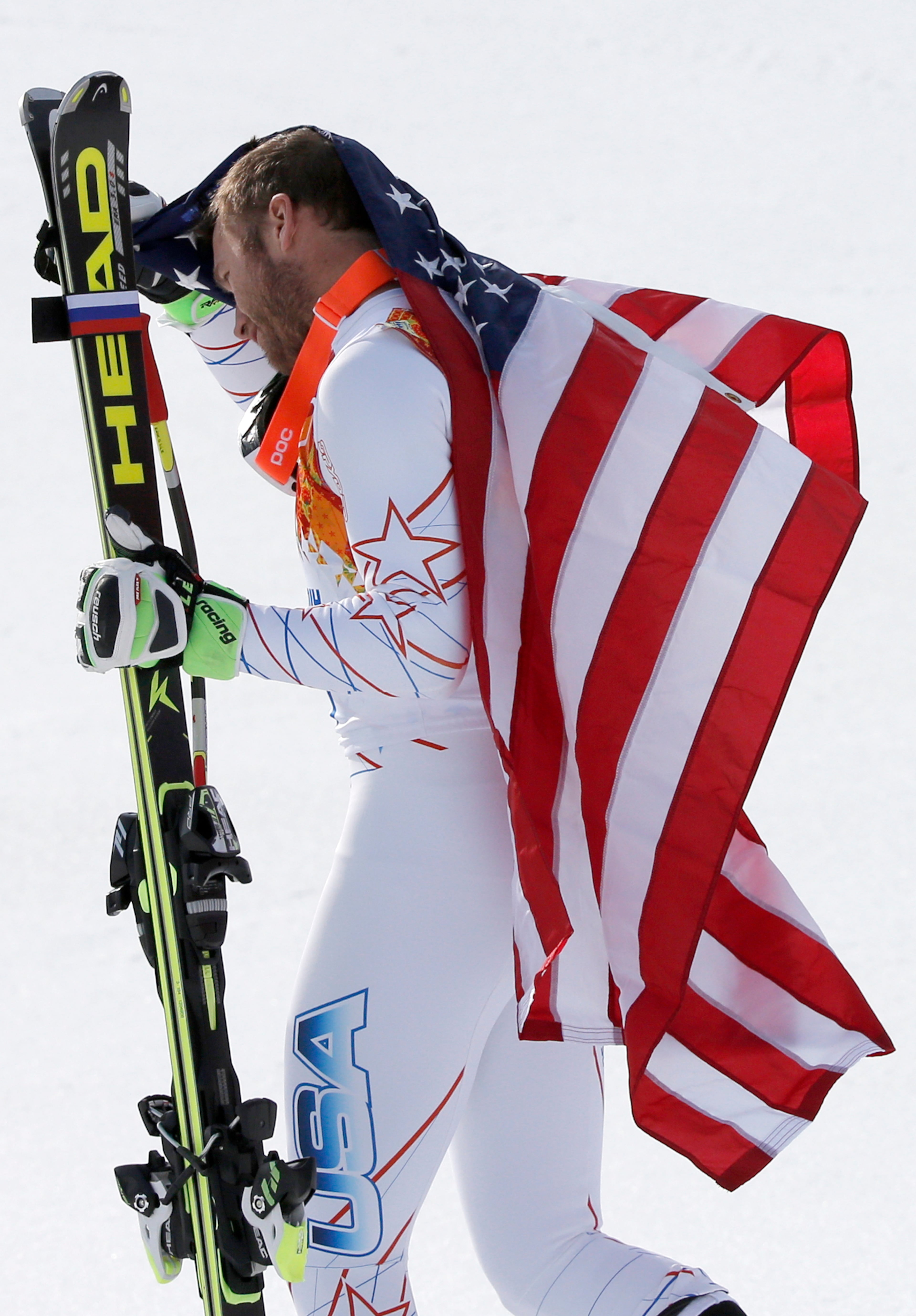Men's super-G joint bronze medal winner Bode Miller of the United States leaves a flower ceremony at the Sochi 2014 Winter Olympics, Sunday, Feb. 16, 2014, in Krasnaya Polyana, Russia. (AP Photo/Christophe Ena)