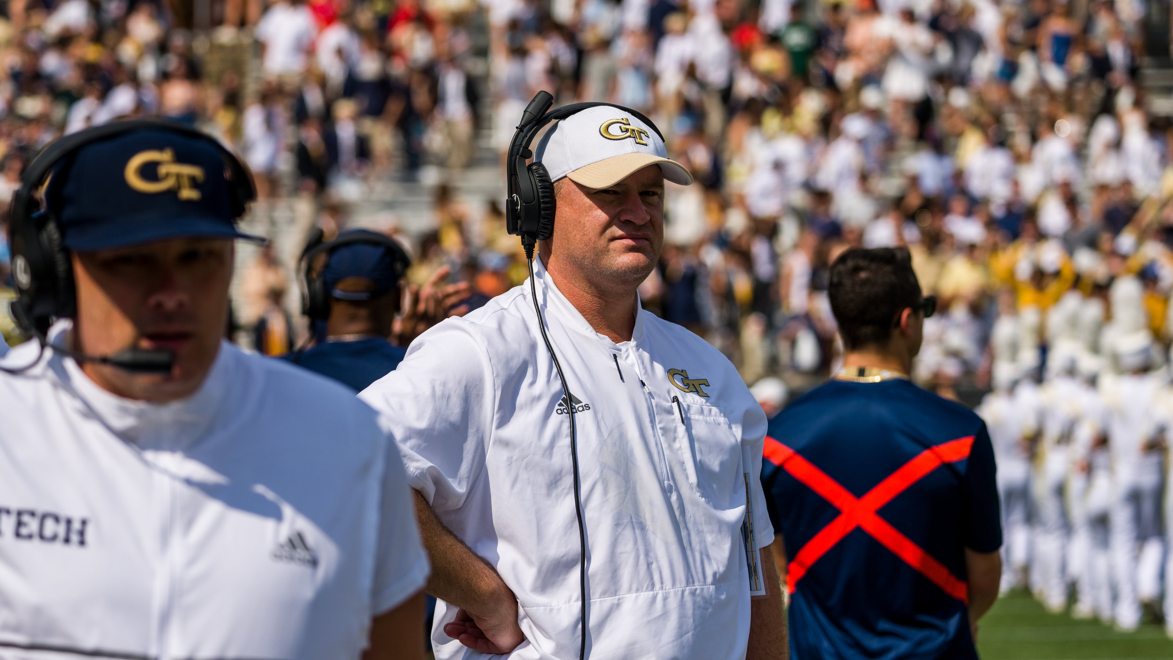 Georgia Tech interim coach Brent Key (white cap) stands on the sideline at the Yellow Jackets' game vs. Ole Miss Sept. 17, 2022 at Bobby Dodd Stadium. It proved the final home game as head coach for Geoff Collins (foreground). (Danny Karnik/Georgia Tech Athletics)
