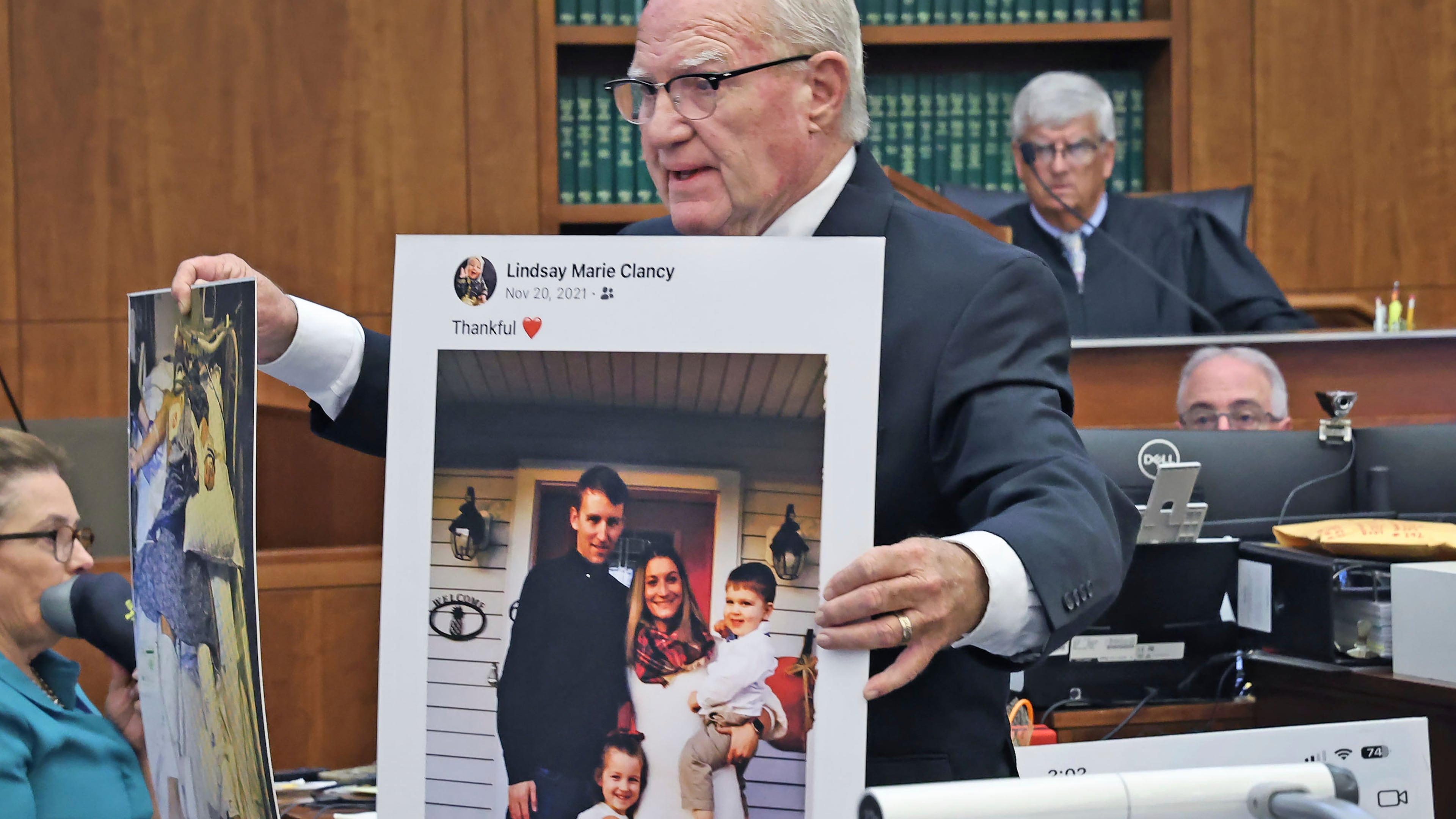 Defense attorney Kevin Reddington holds up a picture of th Clancy family before the murders during closing arguments in the Lindsay Clancy murder trial at Plymouth Superior Court in Plymouth, Mass., Thursday, Aug. 27, 2026. (Greg Derr/The Patriot Ledger via AP, Pool)
