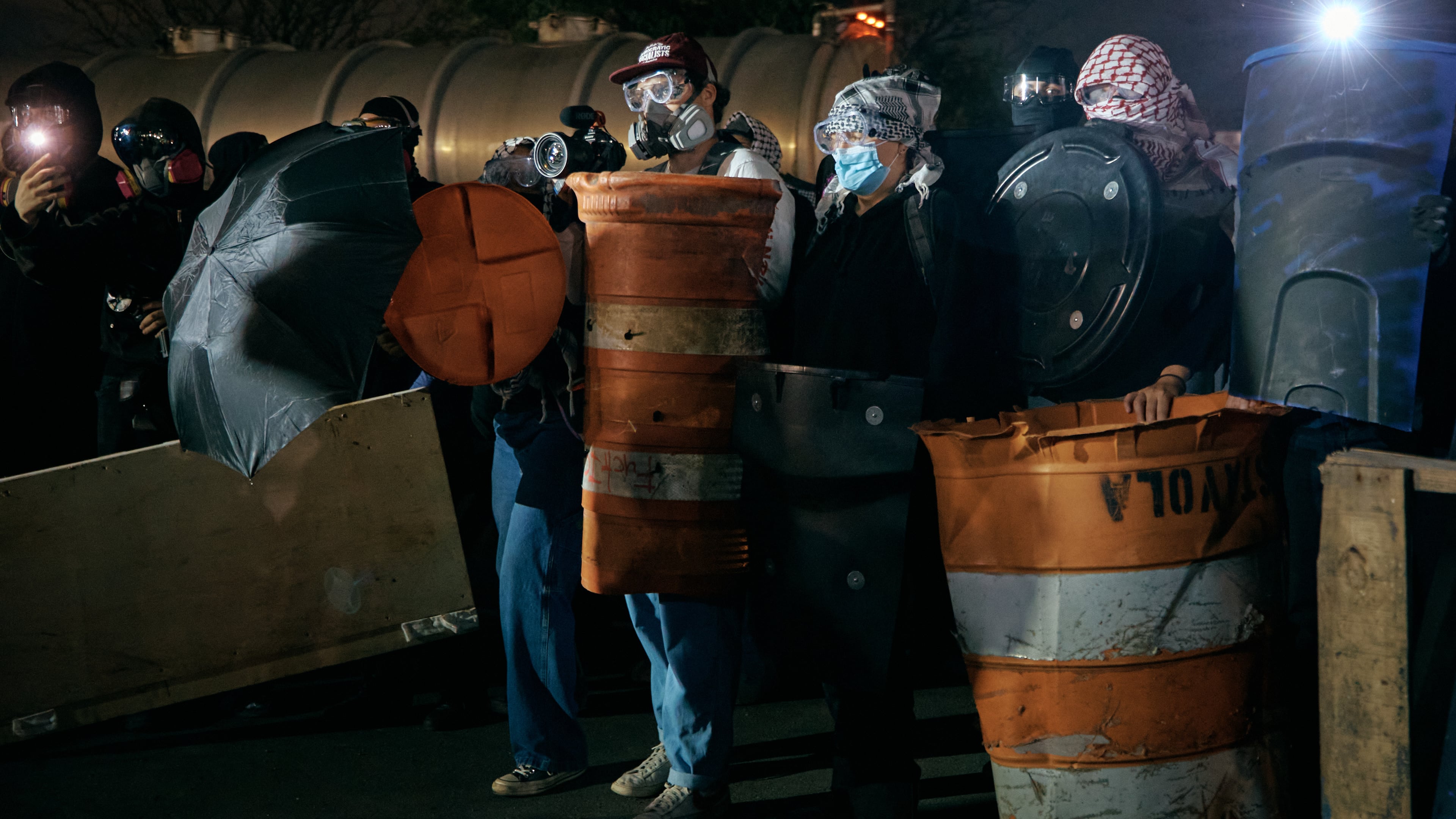 Protestors barricade the entrance gates outside the Delaney Hall detention on Wednesday, May 27, 2026, in Newark, N.J. Inside the facility, detainees carried out a labor and hunger strike for days over alleged living conditions. (AP Photo/Andres Kudacki)