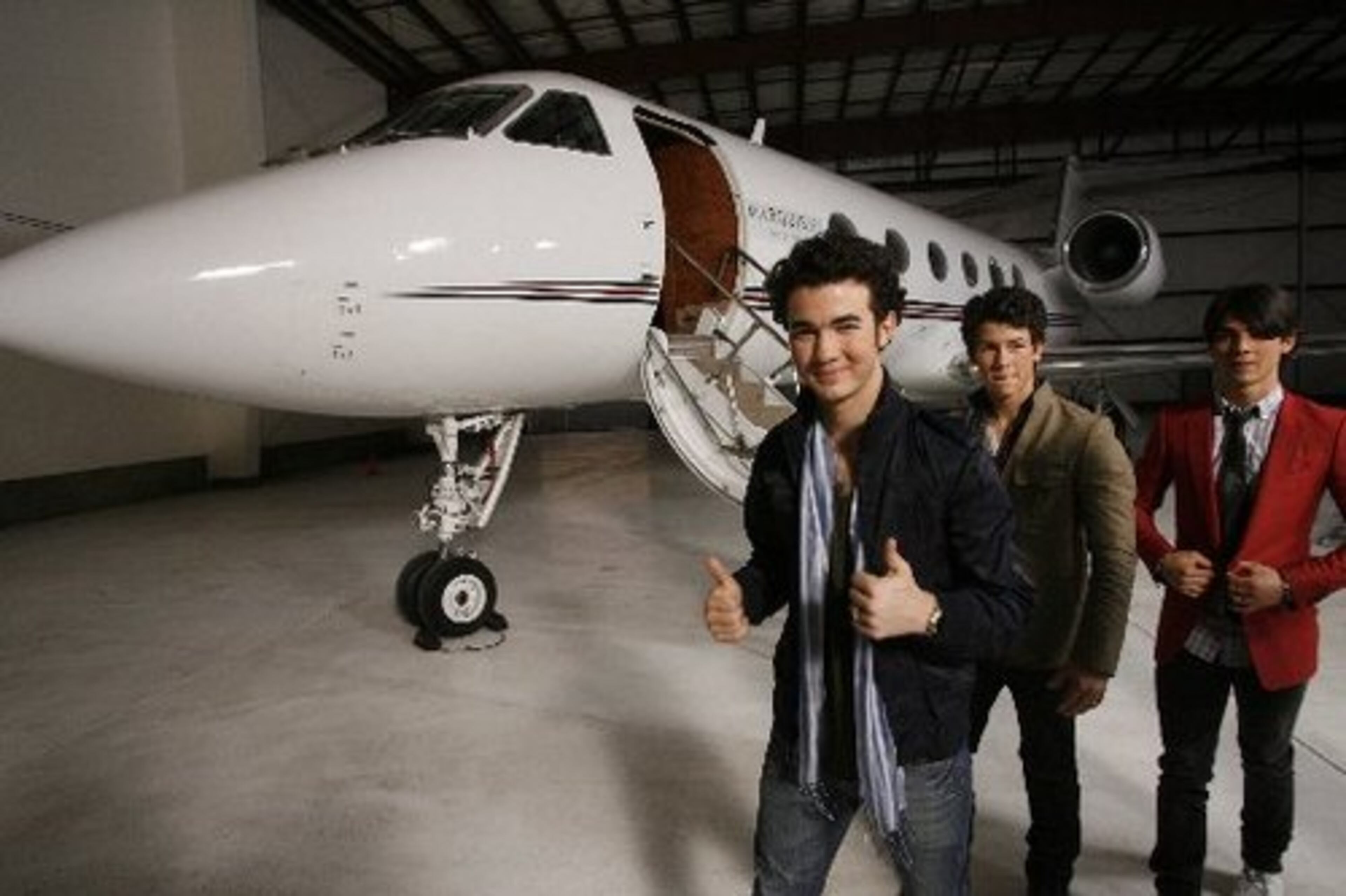 The brothers smile after arriving at the Million Air hangar in Burbank, Calif. in the Gulfstream 450 jet they will use for their their upcoming tour.