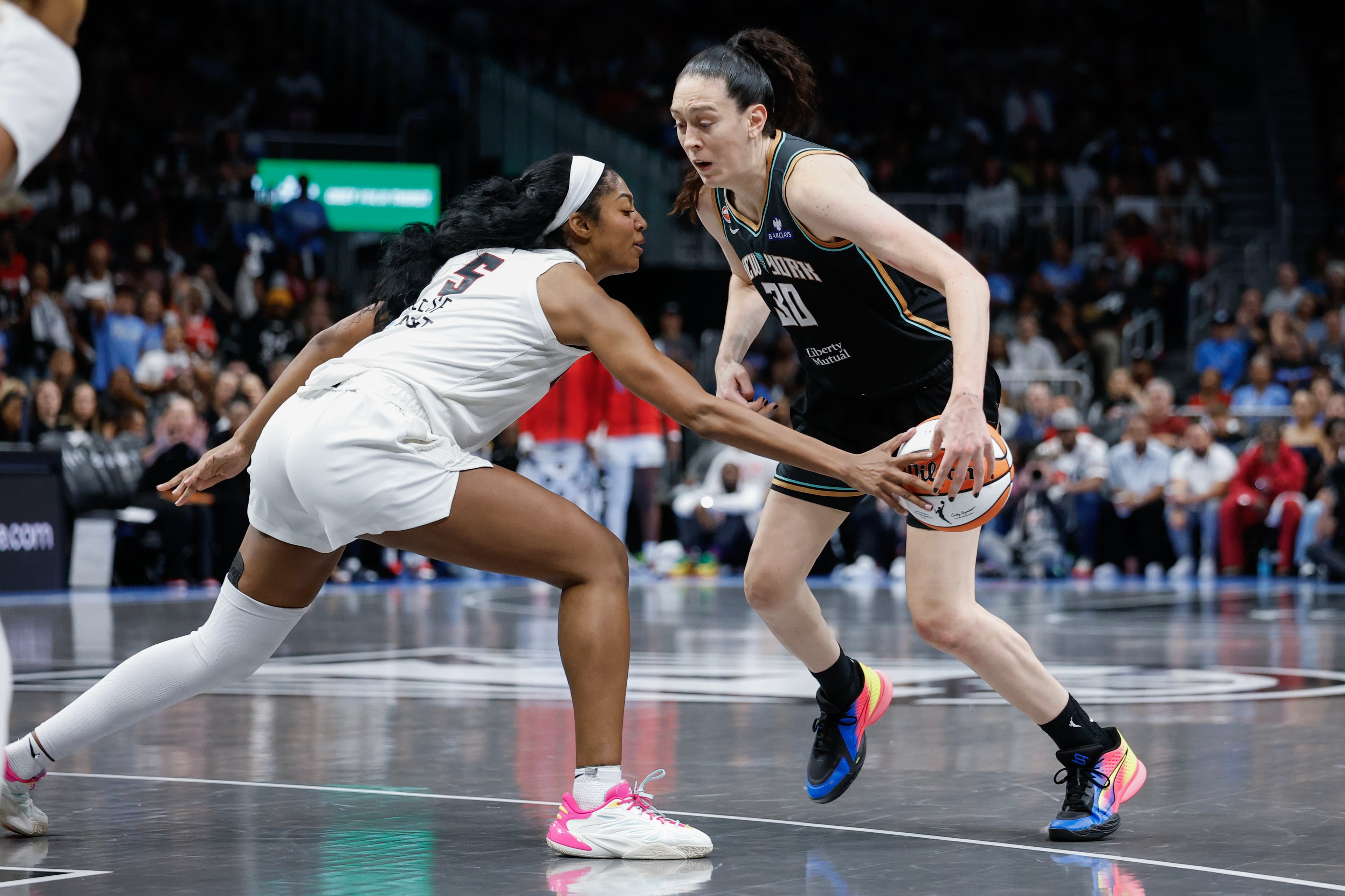 Atlanta Dream forward Angel Reese (5) makes a steal against New York Liberty forward Breanna Stewart (30) during the second half of a WNBA semifinal playoff game 1 between the Atlanta Dream and the New York Liberty, Sunday, Oct. 4, 2026, in Atlanta. (Erik S. Lesser for the AJC)