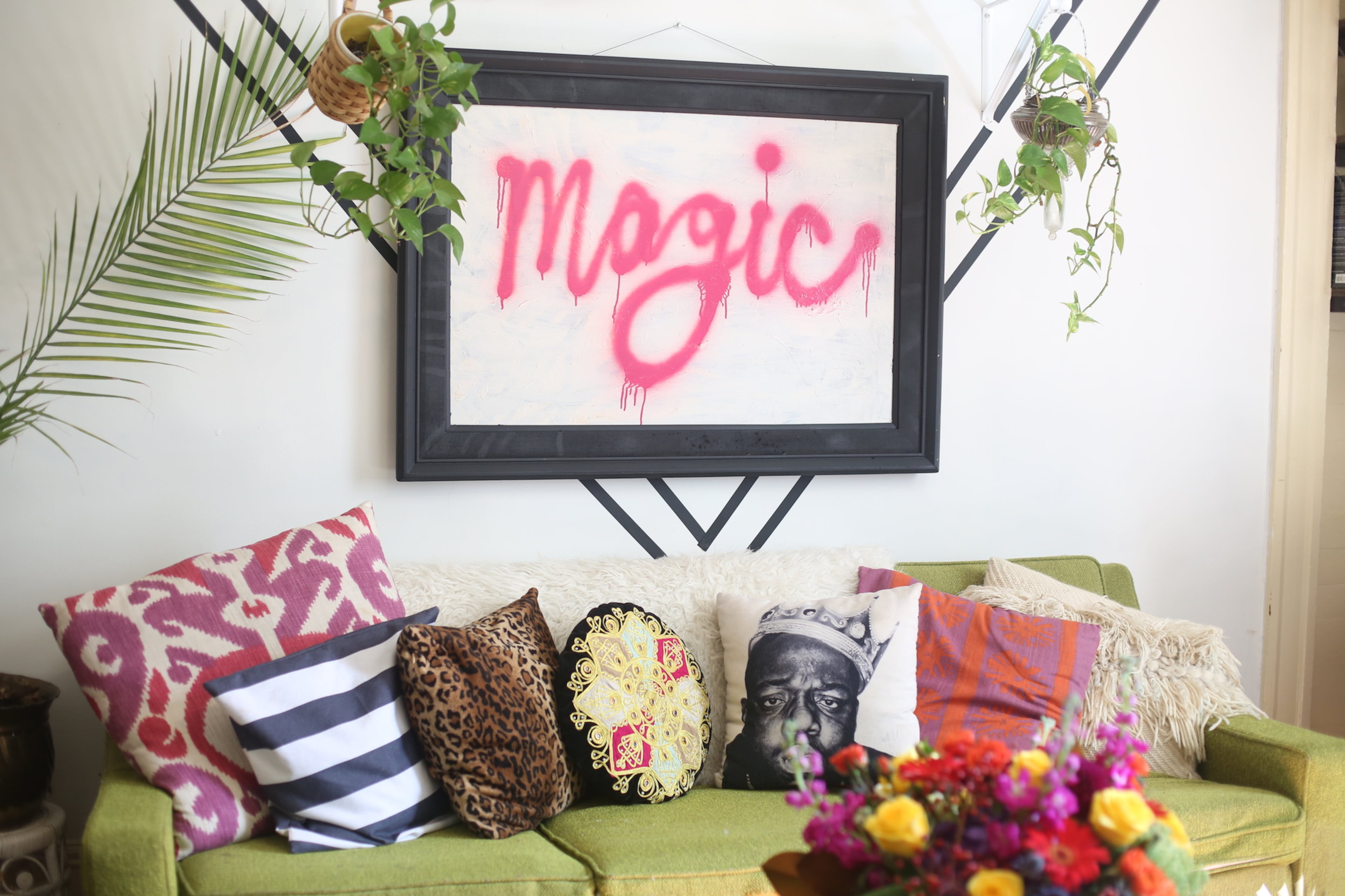 Pink and greenery mix, from original art to thrifted furniture, in Augusta Wheeler's Grant Park home. The Biggie Smalls pillow is one of the musical references in the decor, said Wheeler, whose sons are named Cash and Lennon.