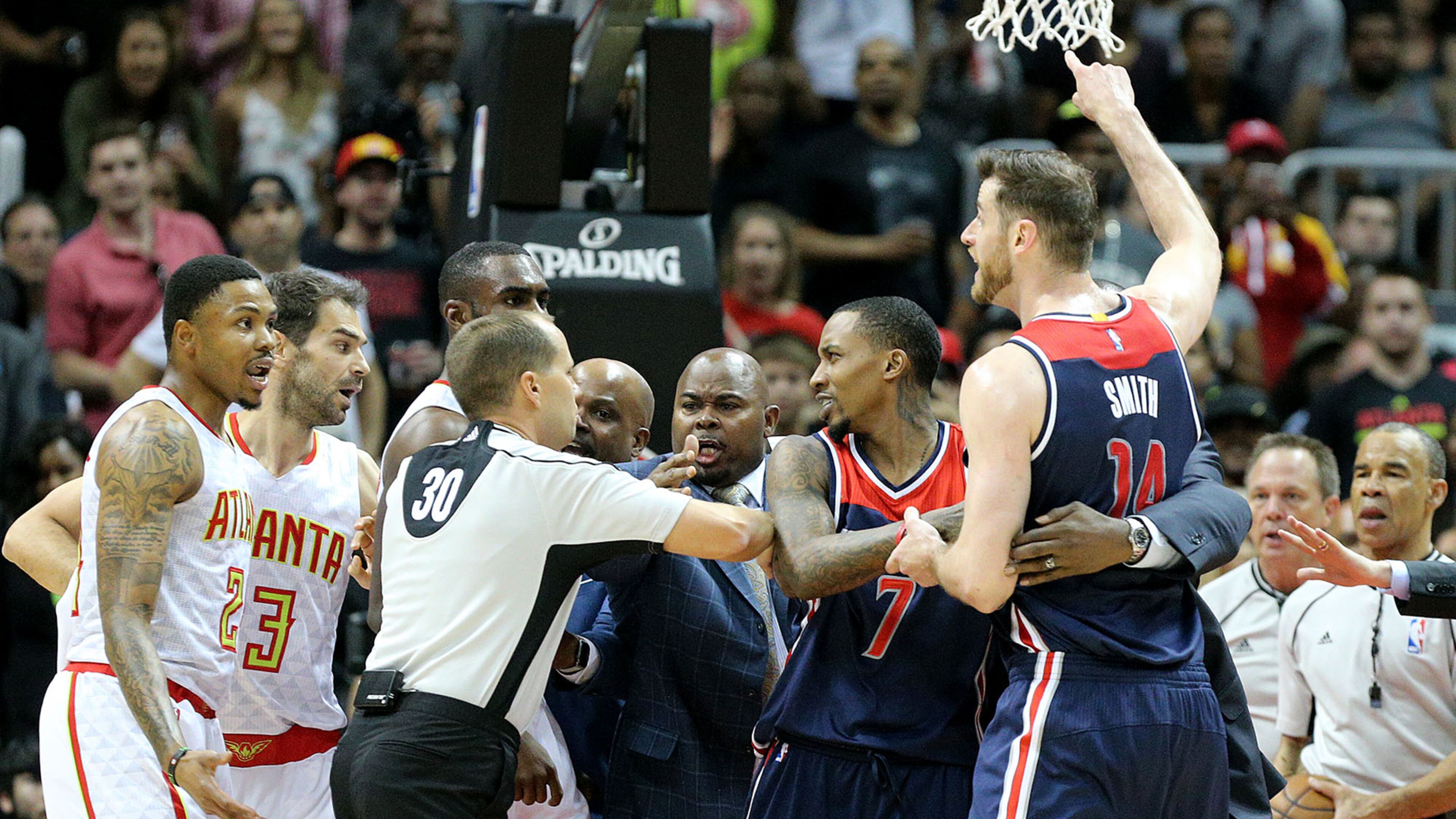 Officials separate Kent Bazemore (far left) of the Hawks and Jason Smith (far right) of the Wizards, who both received tecnical fouls, during an altercation in Game 6 of a first-round NBA basketball playoff series on Friday, April 28, 2017, in Atlanta. Curtis Compton/ccompton@ajc.com