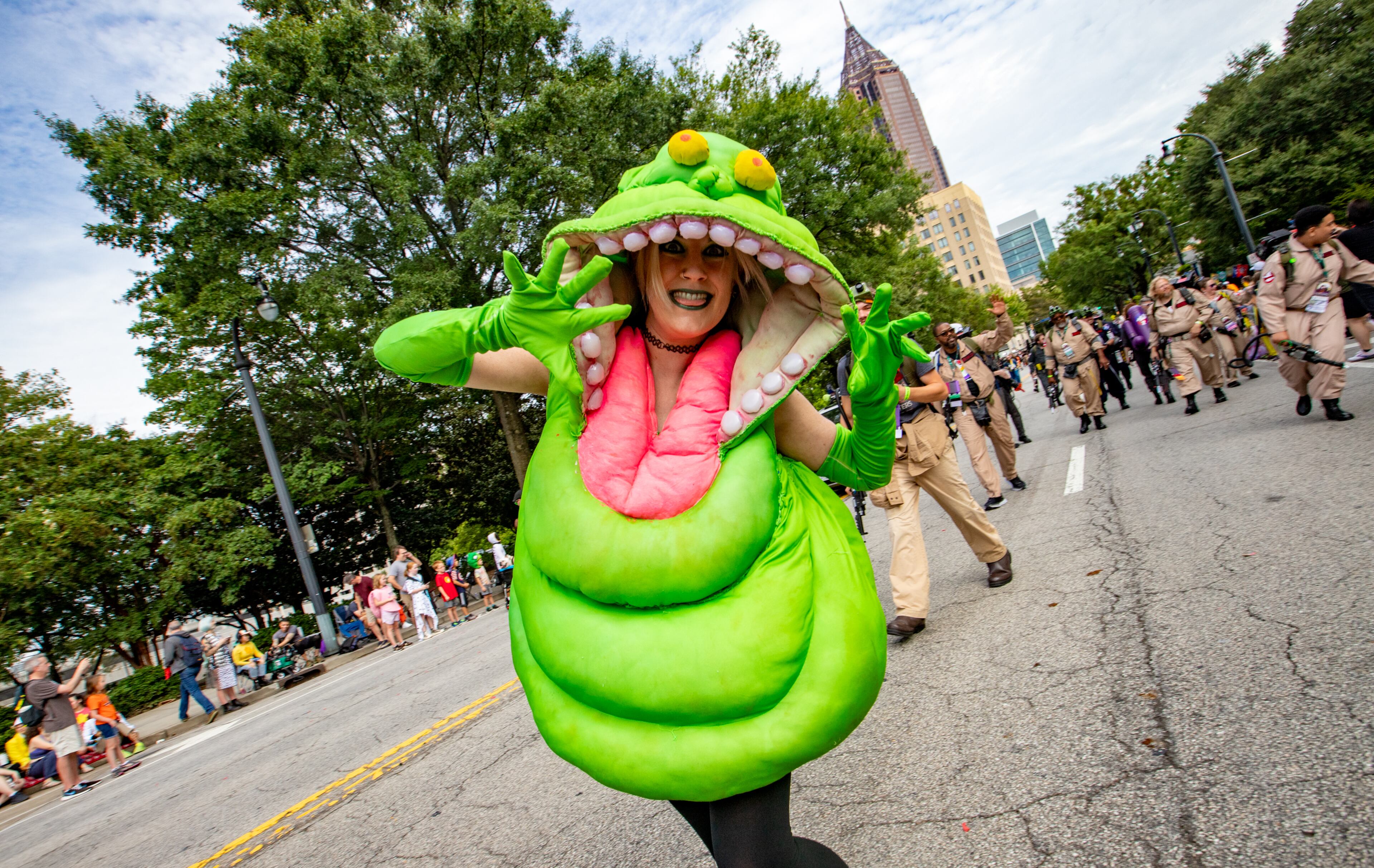 Cara Caravan is Slimer and is surrounded by Ghostbusters at the annual Dragon Con Parade on Saturday, Sept 2, 2023. (Jenni Girtman for The Atlanta Journal-Constitution)
