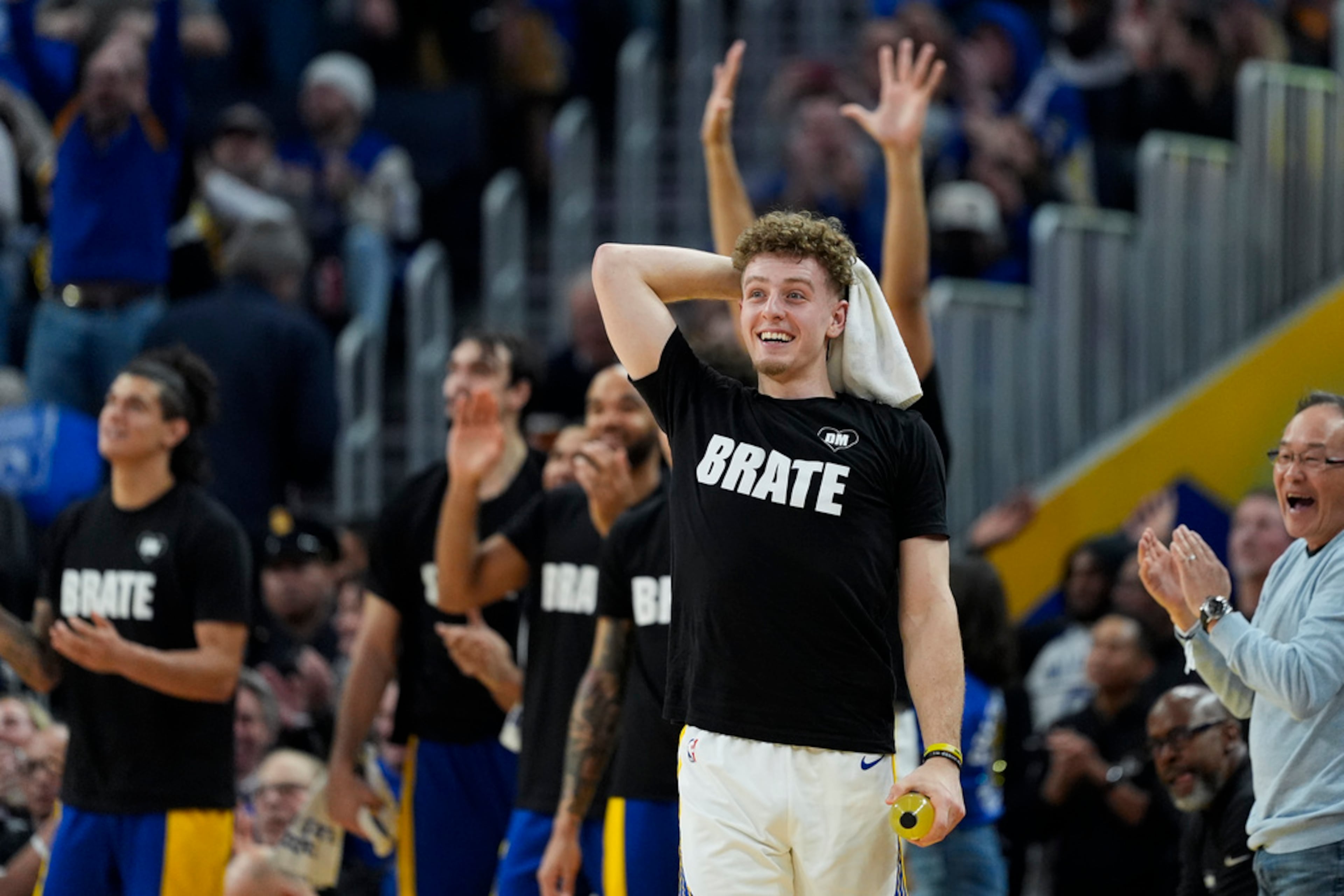 Golden State Warriors guard Brandin Podziemski reacts after a dunk by forward Andrew Wiggins during the first half of an NBA basketball game against the Atlanta Hawks, Wednesday, Jan. 24, 2024, in San Francisco. (AP Photo/Godofredo A. Vásquez)