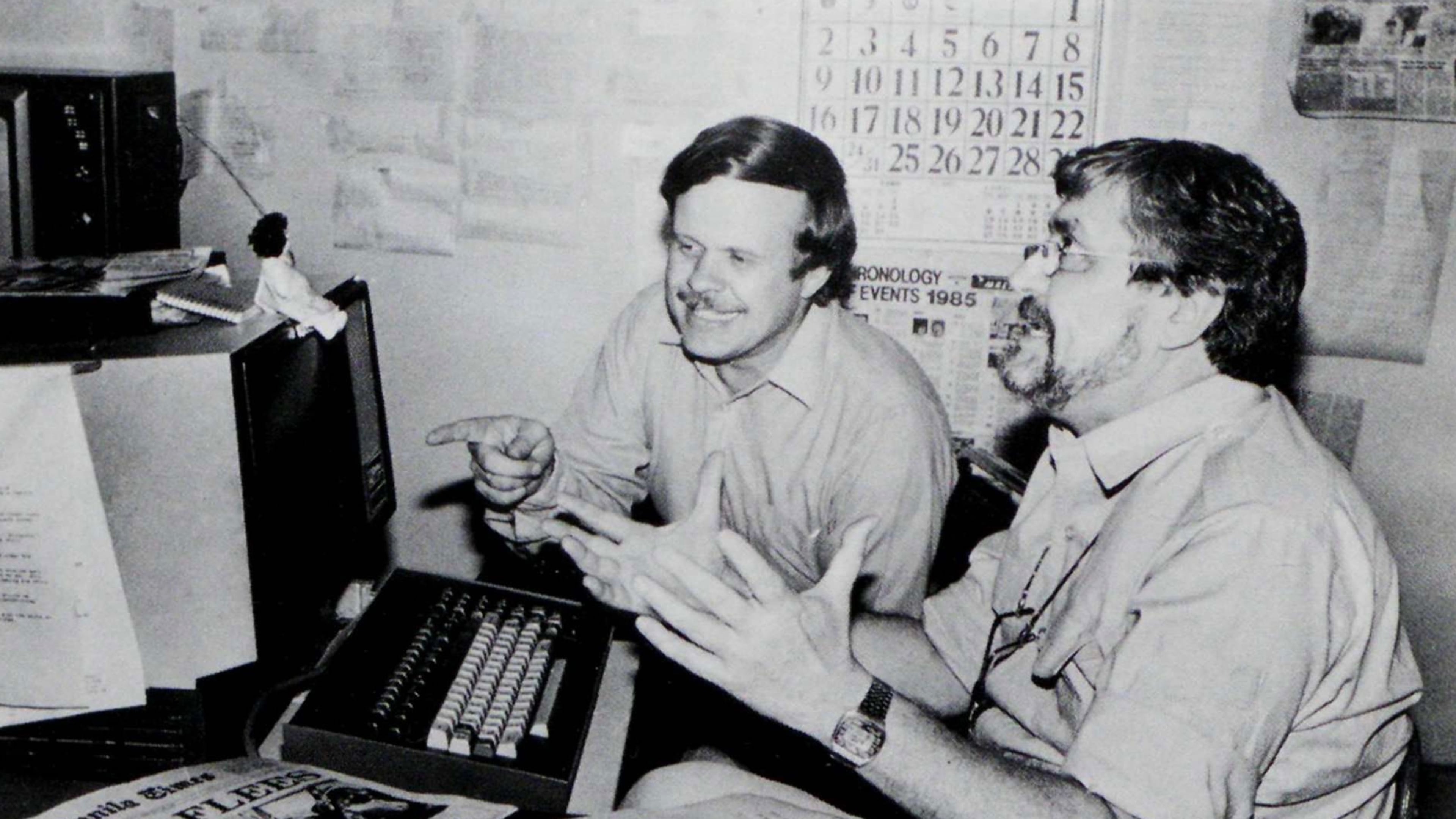 In this undated photo published in The AP World in 1986, Manila bureau chief David Briscoe, left, and Asia news director Richard Pyle discuss a story. (AP Photo)
