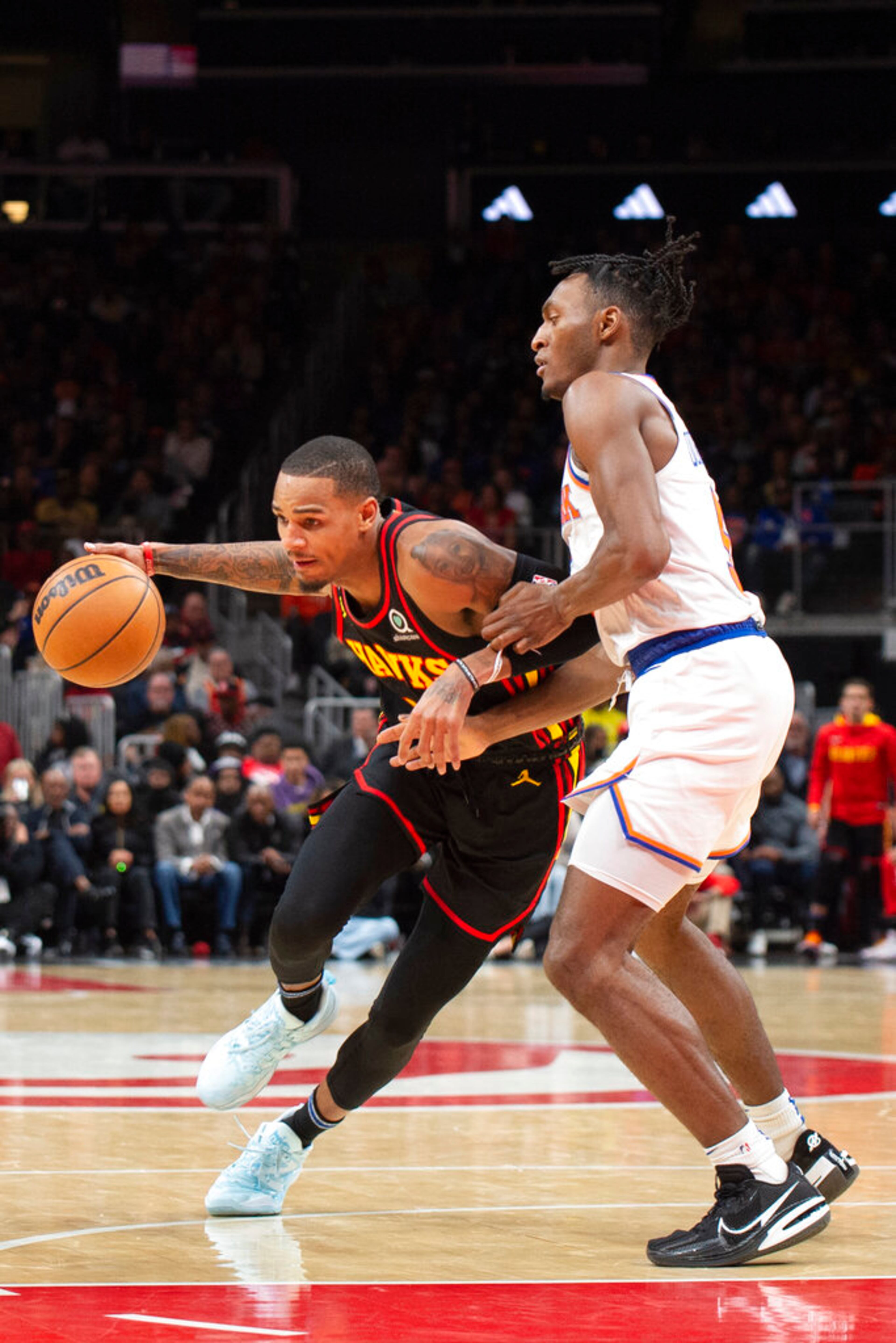 Atlanta Hawks guard Dejounte Murray drives against New York Knicks guard Immanuel Quickley during the second half of an NBA basketball game, Friday, Jan. 20, 2023, in Atlanta. (AP Photo/Hakim Wright Sr.)