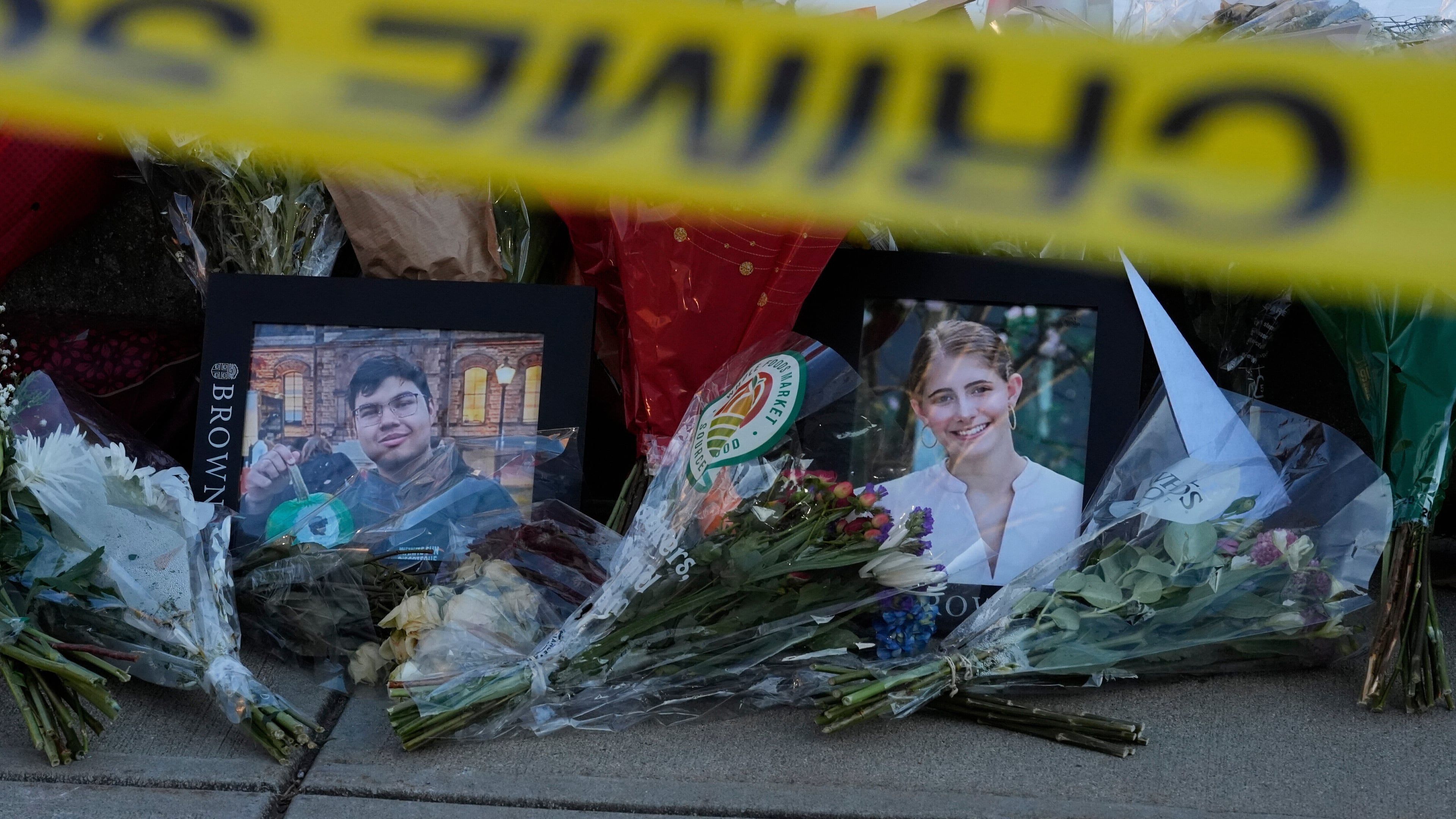 FILE - Photos of Brown University shooting victims MukhammadAziz Umurzokov, left, and Ella Cook, lay on a makeshift memorial outside the Engineering Research Center, Dec. 16, 2025, in Providence, R.I. (AP Photo/Robert F. Bukaty, File)