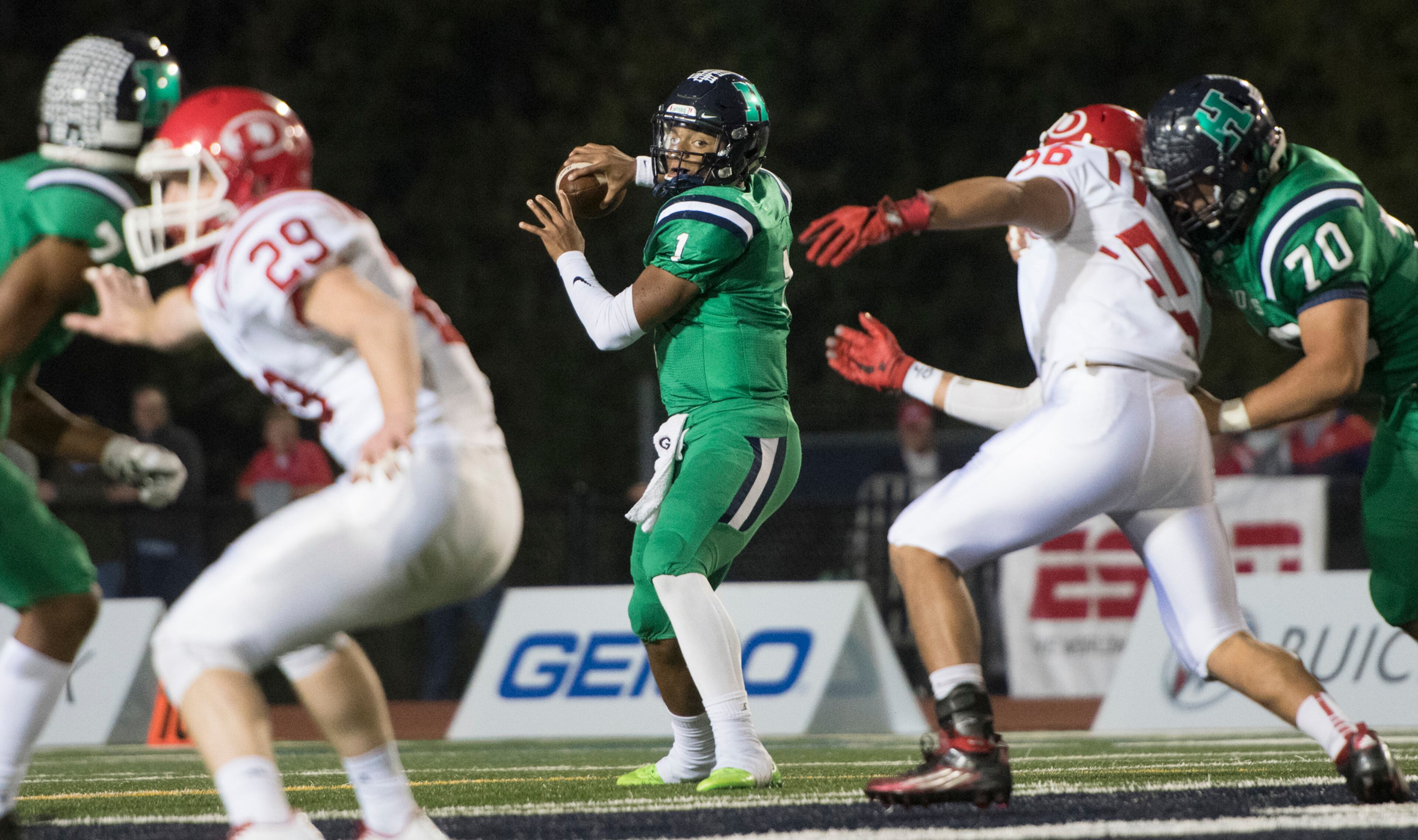 Harrison quarterback Justin Fields (1) drops back to pass as Dalton defensive end Kevin Diaz (56) is blocked by lineman Tonny Garcia (70) and linebacker Jack Ridley (29) is blocked by Dawson Brown, left, during a high school football game on Thursday, Oct. 19, 2017, in Kennesaw, Ga. (Special to the Atlanta Journal-Constitution, John Amis )