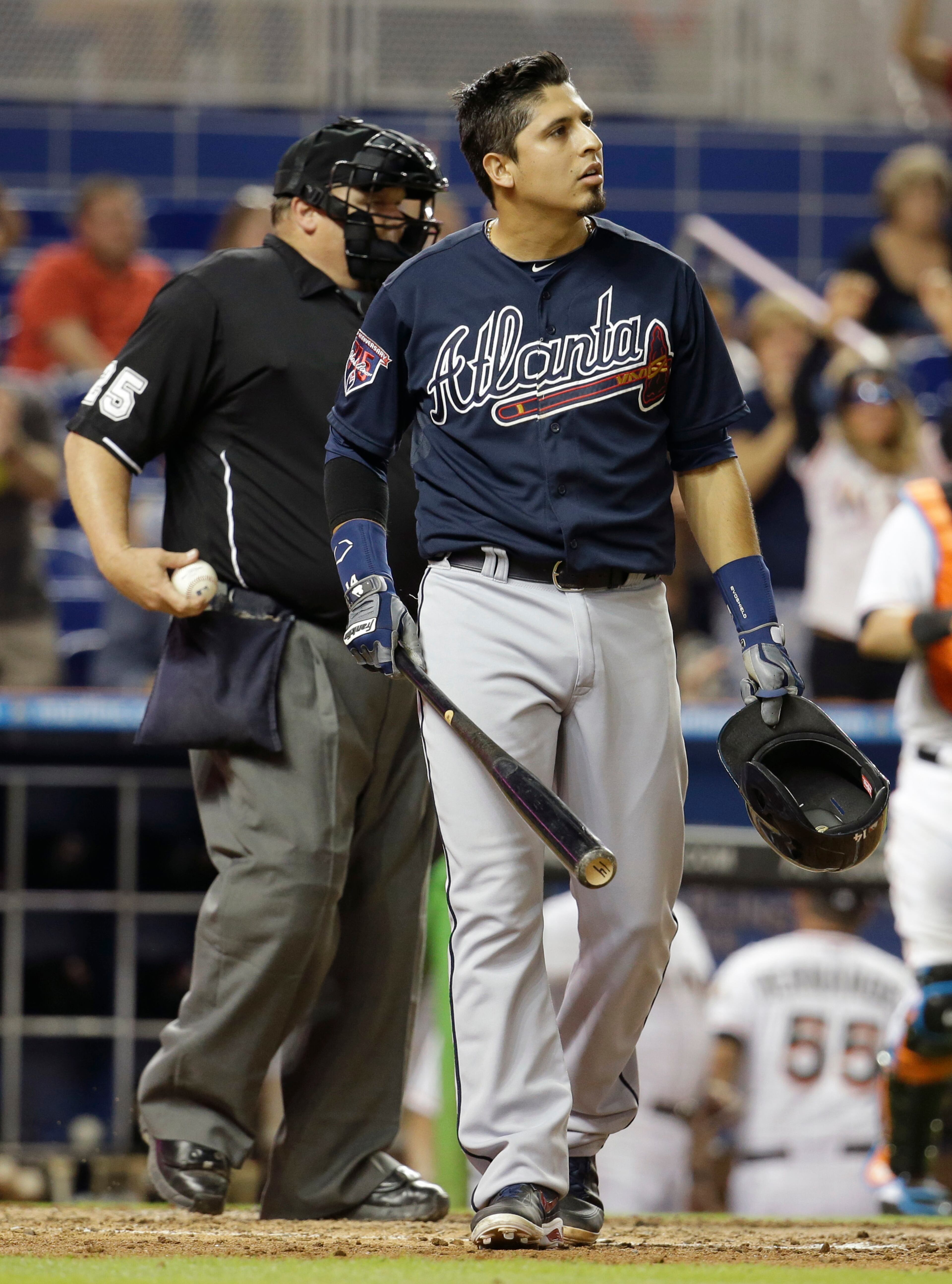 Atlanta Braves' Ramiro Pena walks away from the plate after striking out with the bases loaded in the eighth inning of a baseball game against the Miami Marlins, Thursday, May 1, 2014, in Miami. The Marlins defeated the Braves 5-4. (AP Photo/Lynne Sladky)