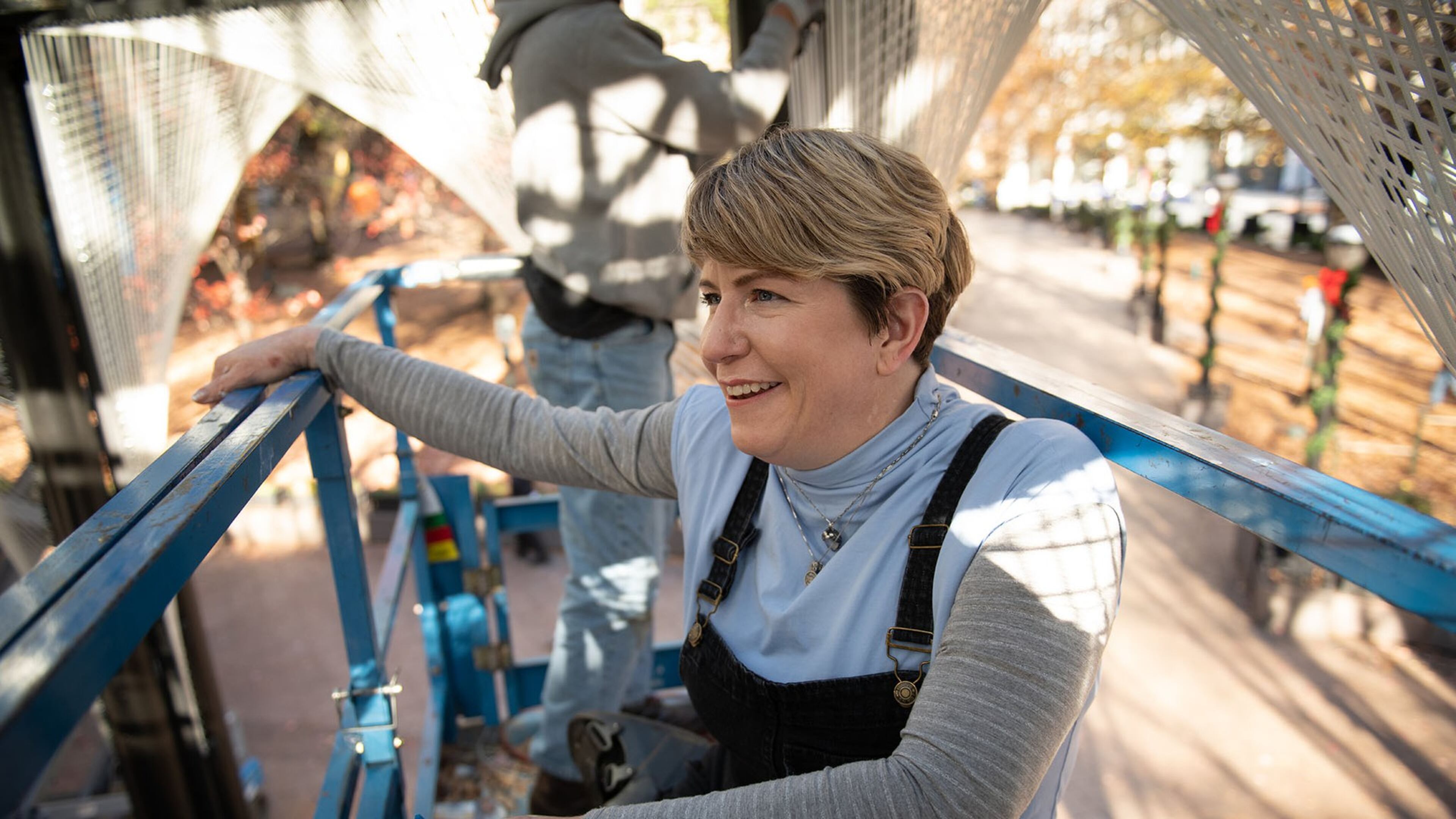Megan Mosholder works on her light-based sculpture as part of “PRISM: Winter Lights in Woodruff Park.” PHOTO BY ELISSA BENZIE