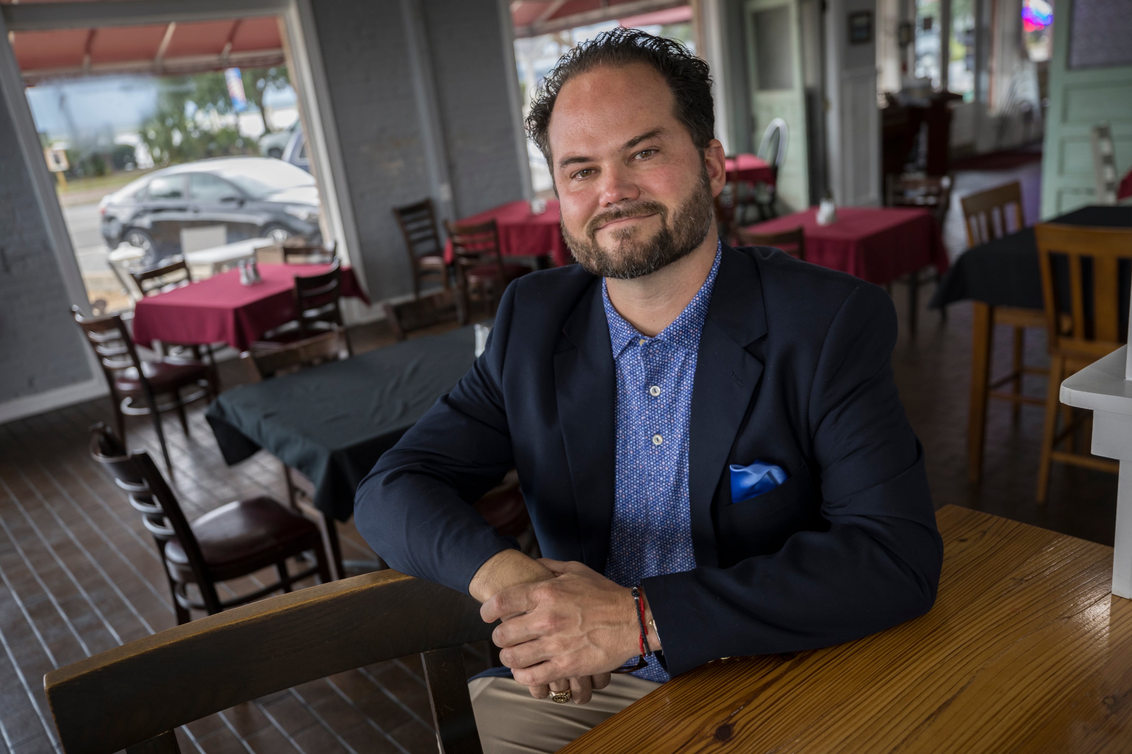 Bert Guy, the owner of Capt. Seagle's, sits in the dinning area of his restaurant in the heart of the historic downtown with views of the St. Marys river, Monday, July 8, 2024, in St. Marys, Ga. Storm surge from passing Hurricane Dorian pushed the river into the first floor of his historic building. (Stephen B. Morton for The Atlanta Journal-Constitution)