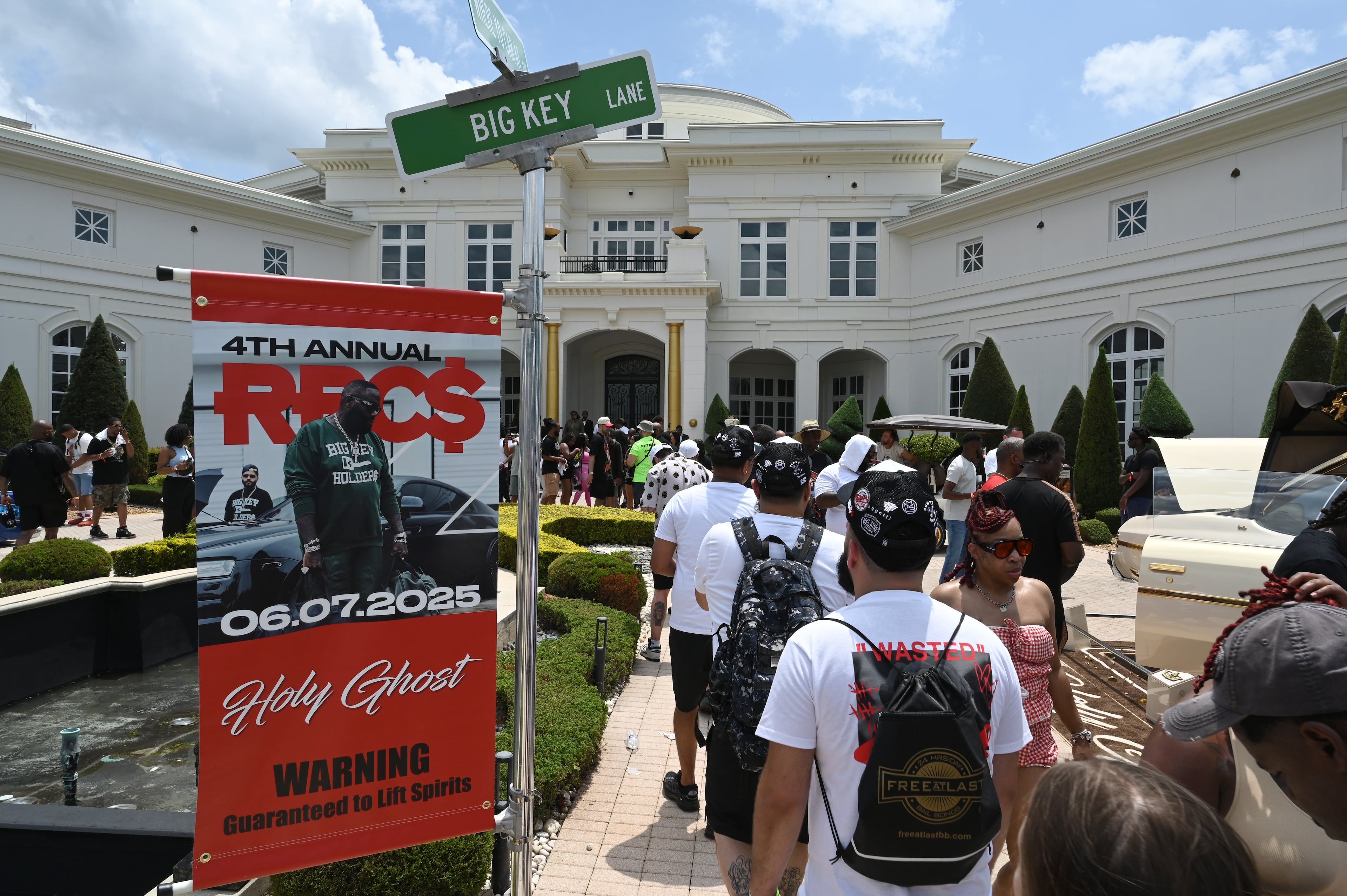 Attendees walk through fleets of classic/custom automobiles, luxury vehicles, boats, RVs and trailers on the front of the mansion during the 4th Annual Rick Ross Car and Bike Show, Saturday, June 7, 2025, in Fayetteville. The 4th Annual Rick Ross Car and Bike Show will include a vendor market with more than 30 vendors, food trucks, fleets of classic/custom automobiles, luxury vehicles, boats, RVs and trailers on the front of the mansion. Stage performances include Plies, Ross' new signee Nino Breeze and Ross himself. (Hyosub Shin / AJC)