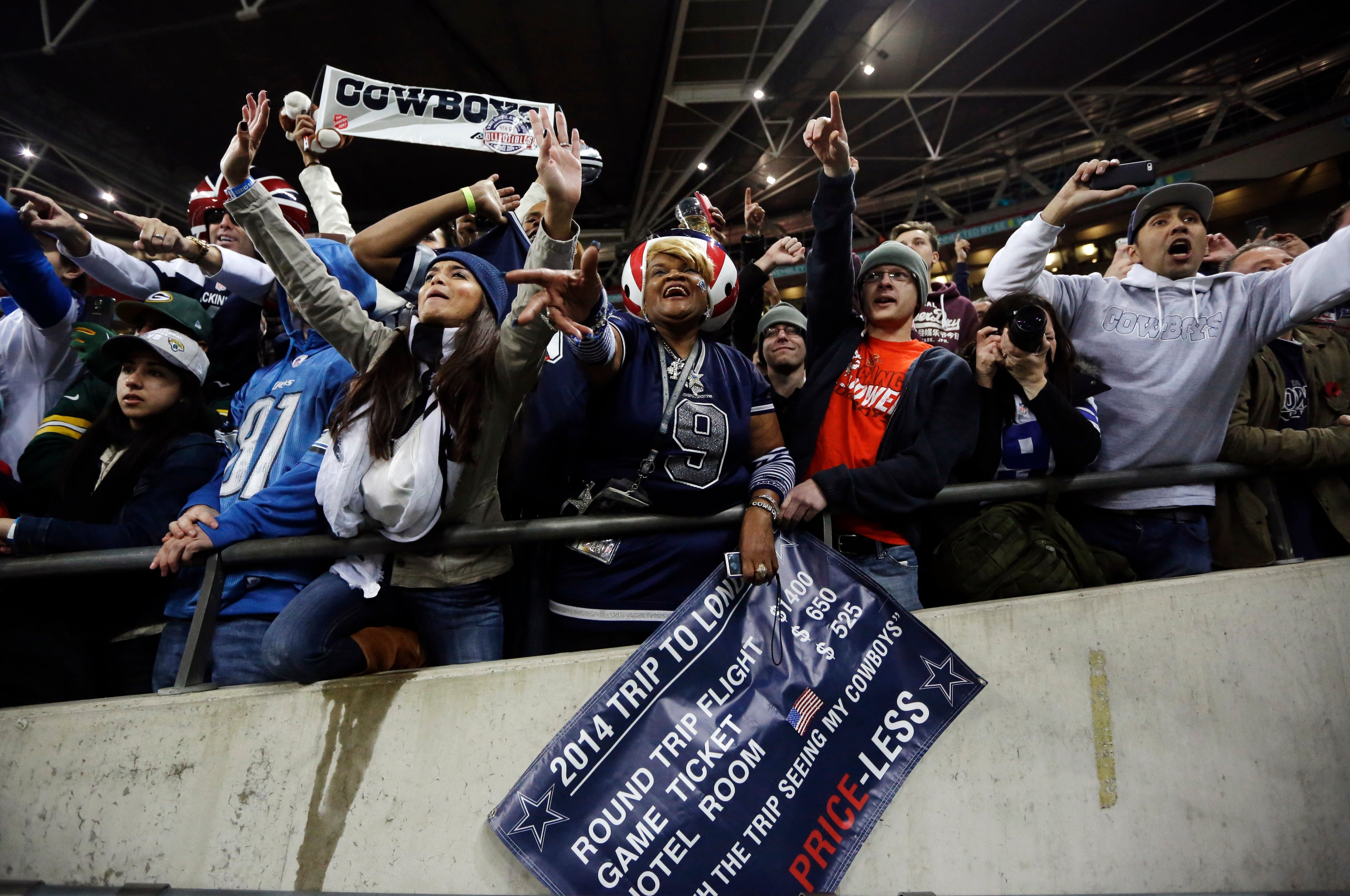 Spectators cheer following the NFL football game between the Dallas Cowboys and the Jacksonville Jaguars at Wembley Stadium, London, Sunday, Nov. 9, 2014. The Cowboys defeated the Jaguars 31-17. (AP Photo/Matt Dunham)