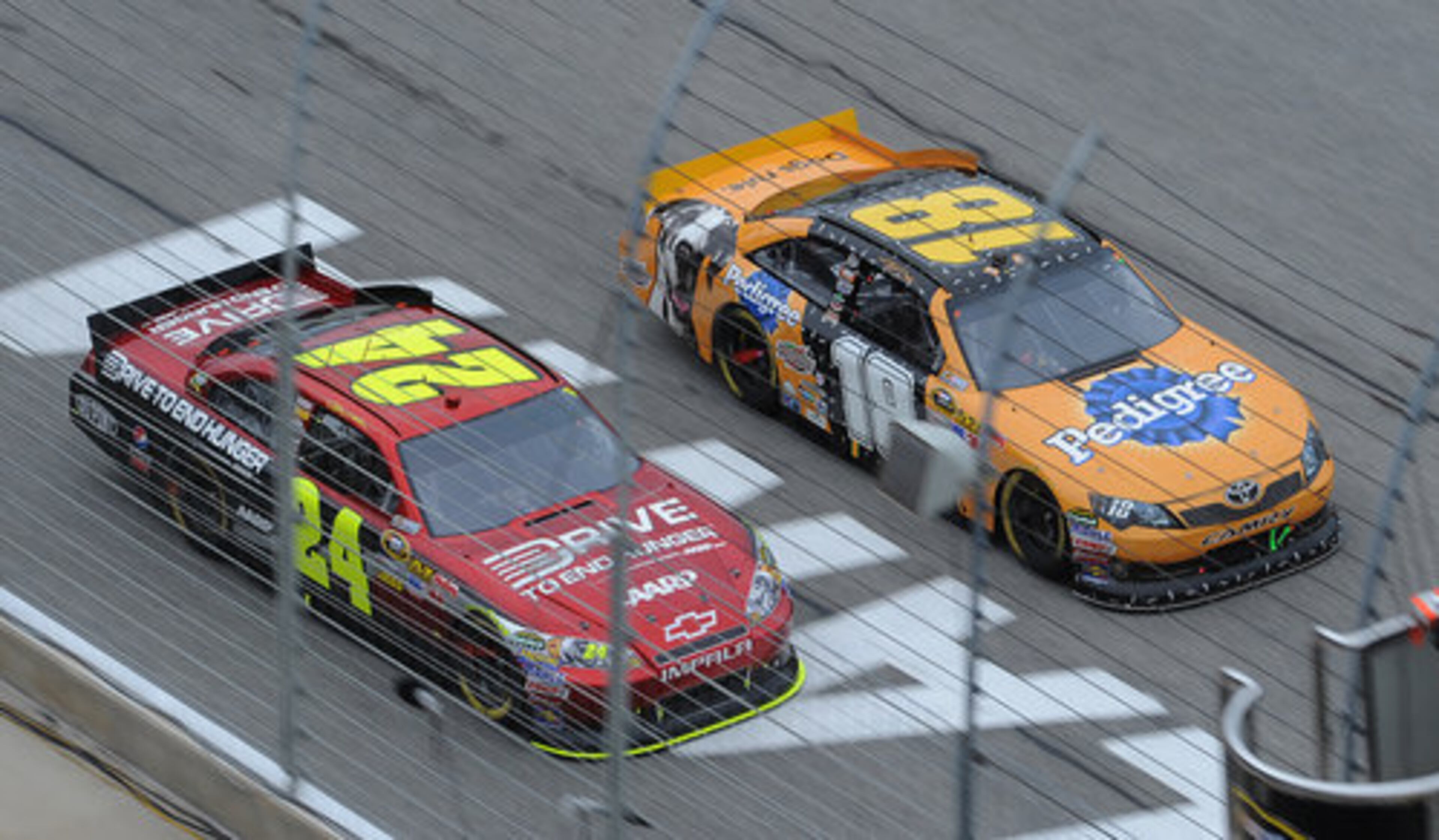 Jeff Gordon (24) races Kyle Busch (18) to the start line on lap 98 during the 52nd Annual AdvoCare 500 at the Atlanta Motor Speedway on Tuesday, Sept 6, 2011. There were several cautions today because of light rain. The race stared today because of rain on Sunday.