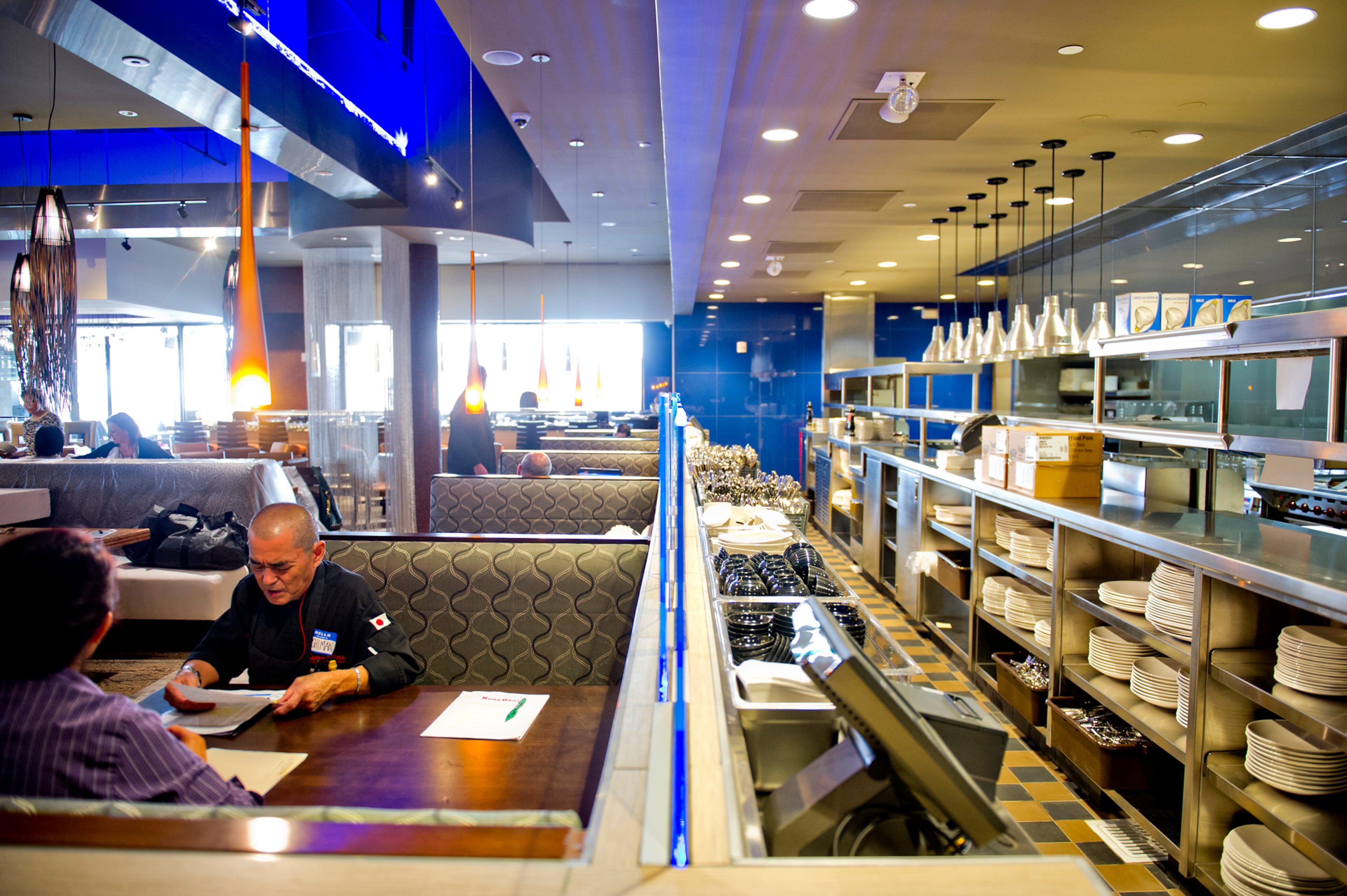 Fred Yamada (left) talks to Sumiko Tranberg are inside the Kona Grill.