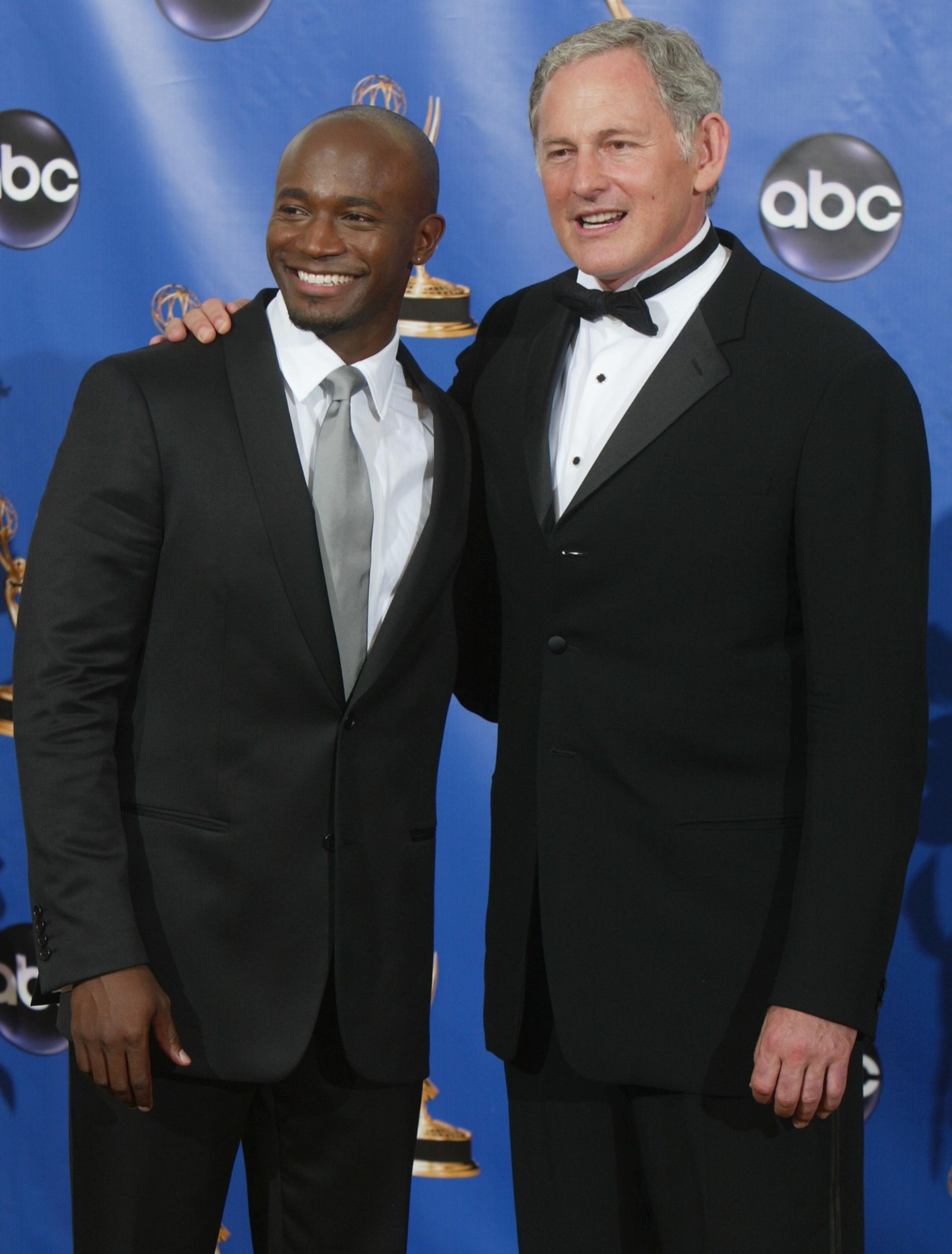 LOS ANGELES - SEPTEMBER 19: Presenters Taye Diggs and Victor Garber pose backstage during the 56th Annual Primetime Emmy Awards at the Shrine Auditorium September 19, 2004 in Los Angeles, California. (Photo by Kevin Winter/Getty Images)