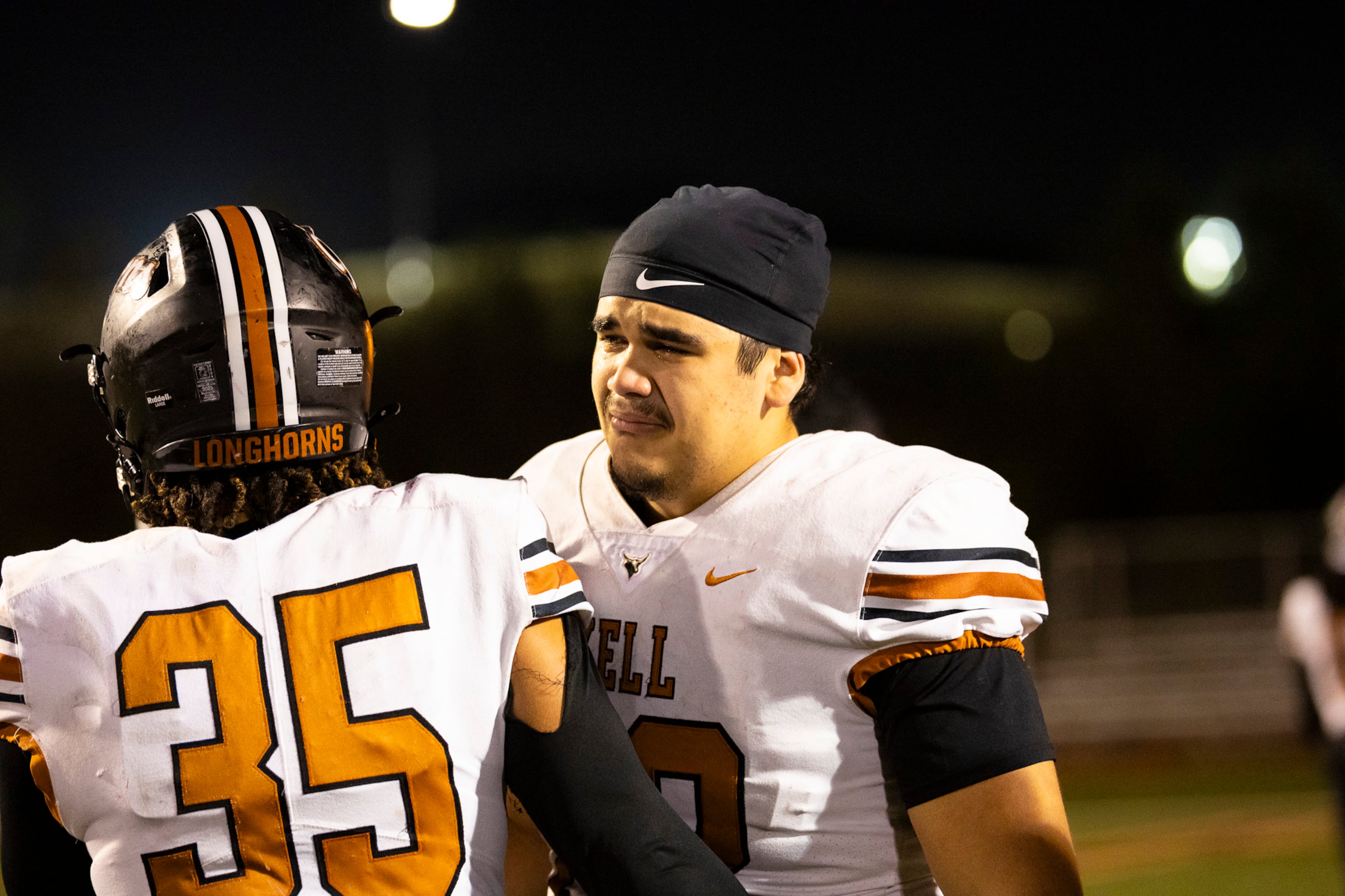 Kell offensive linesman David Ornelas (right) speaks with a teammate after losing their Class 4A semifinal against Creekside on Friday, Dec. 5, 2025, at Creekside High School in Fairburn. (Oscar Guevara Saenz for the AJC)