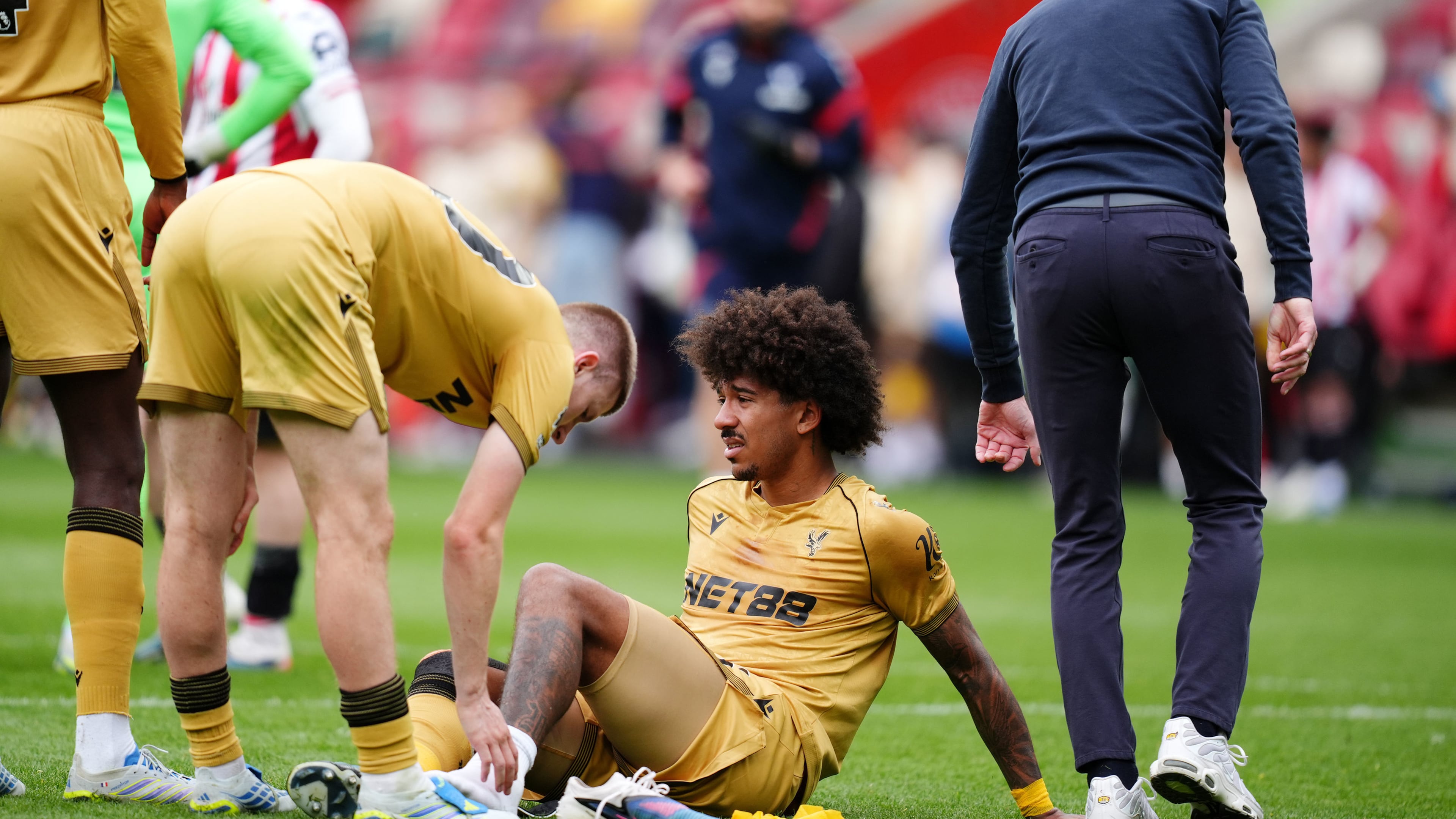 Crystal Palace's Chris Richards, bottom, reacts after after going down with an injury during the Premier League soccer match between Brentford and Crystal Palace, Sunday, May 17, 2026, in London. (John Walton/PA via AP)