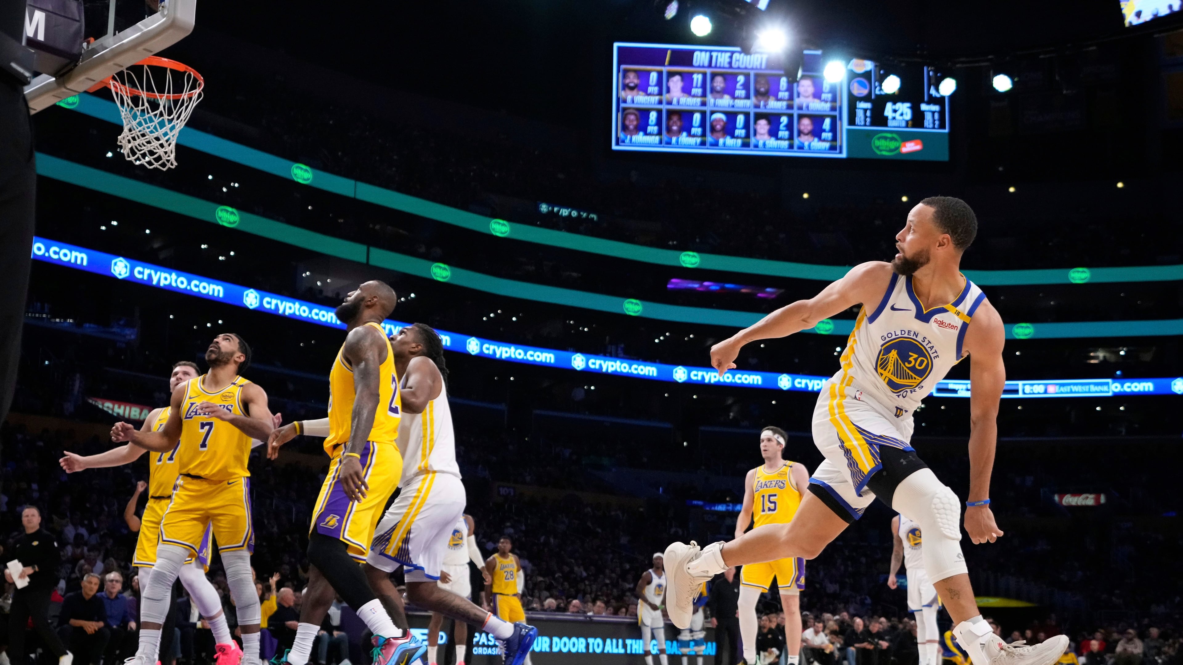 FILE - Golden State Warriors guard Stephen Curry, right, watches his shot go in during the first half of an NBA basketball game against the Los Angeles Lakers in Los Angeles., April 3, 2025. (AP Photo/Mark J. Terrill, File)