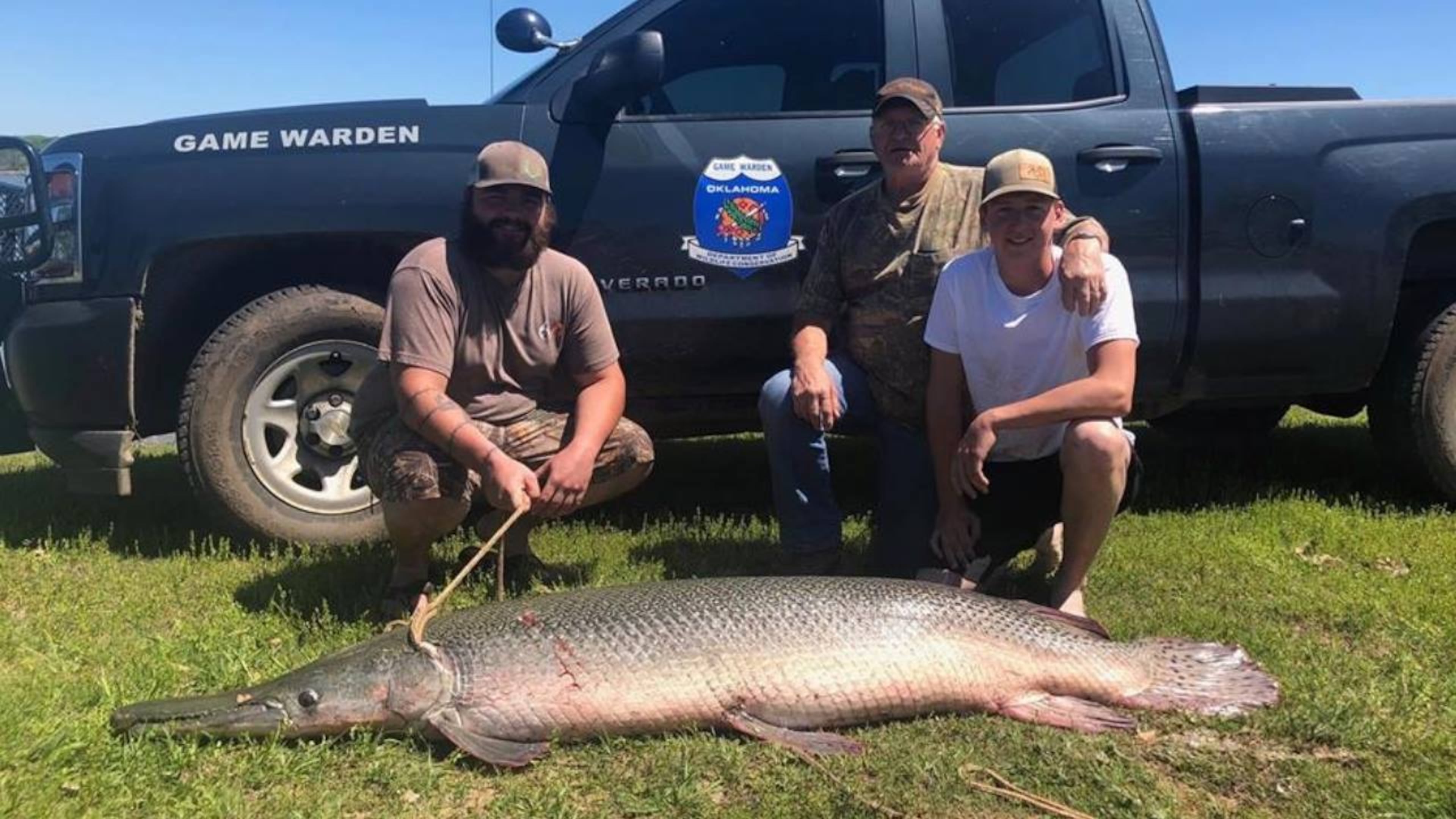 Zachary Sutterfield, left, reeled in a 170-pound alligator gar over the weekend in Oklahoma.