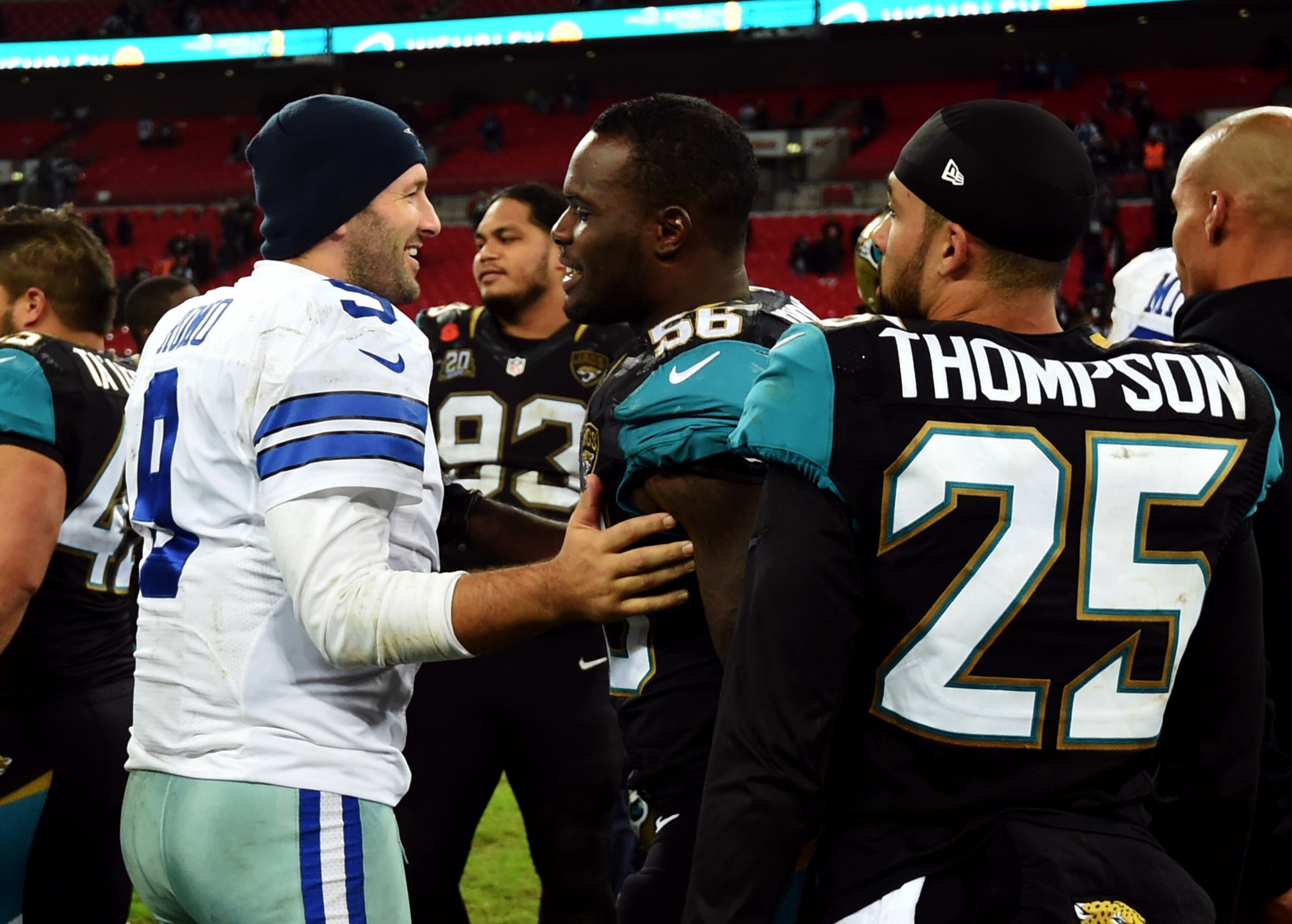 Dallas Cowboys quarterback Tony Romo talks to Jacksonville Jaguars outside linebacker LaRoy Reynolds (56) following their NFL football game at Wembley Stadium, London, Sunday, Nov. 9, 2014. The Cowboys defeated the Jaguars 31-17. (AP Photo/Tim Ireland)