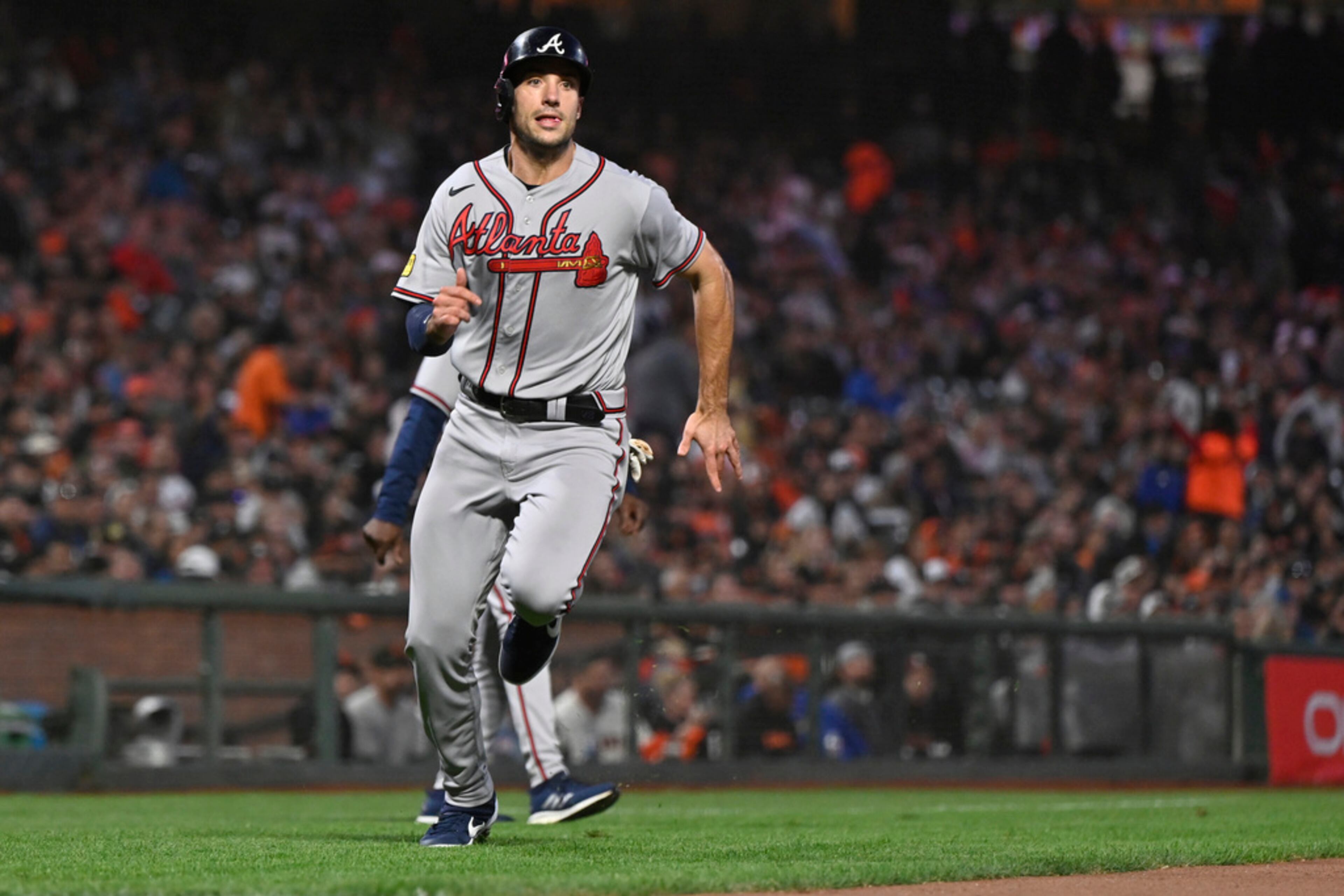 Atlanta Braves' Matt Olson heads home to score against the San Francisco Giants during the fourth inning of a baseball game in San Francisco, Friday, Aug. 25, 2023. (AP Photo/Nic Coury)