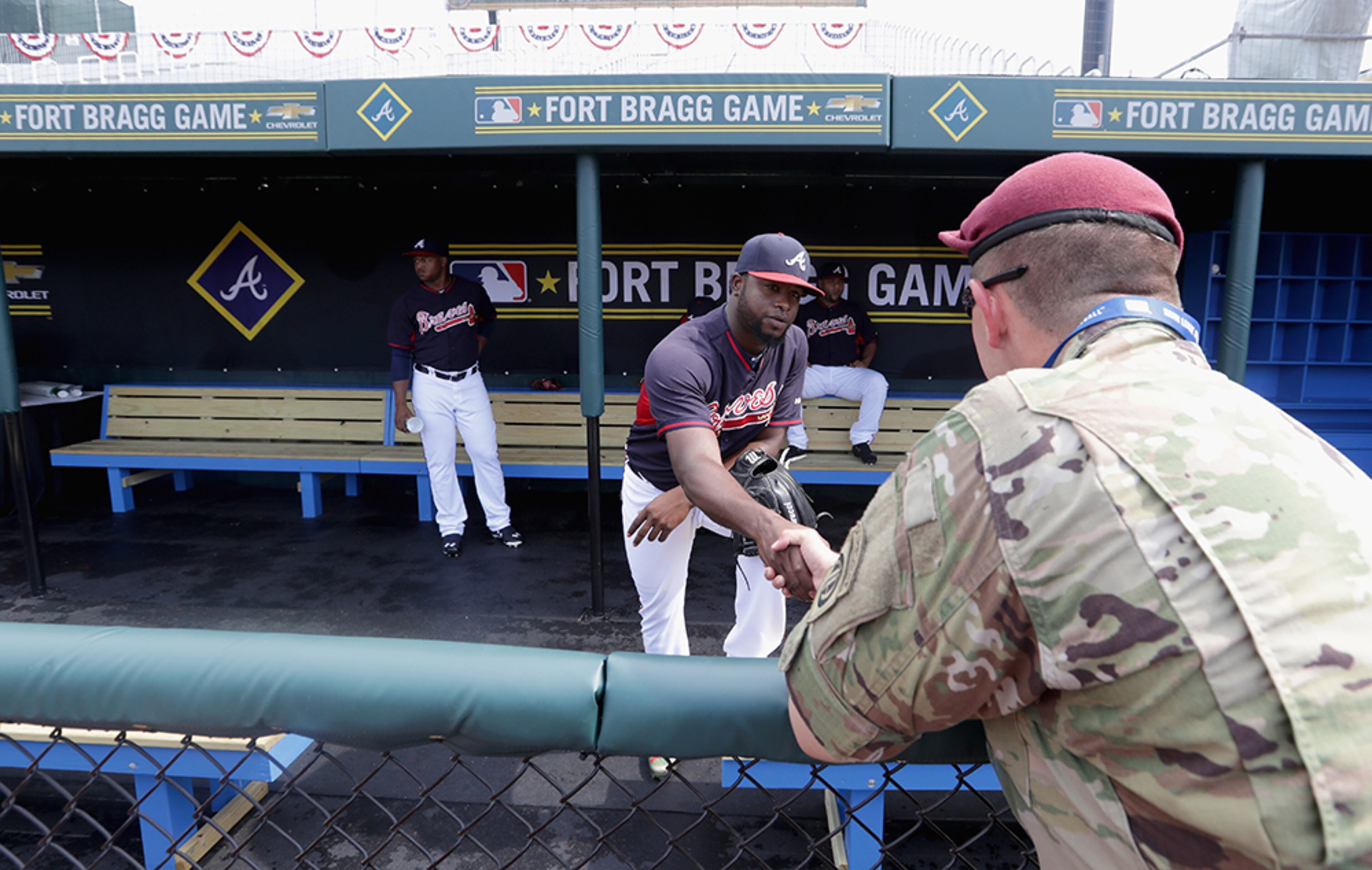 Braves closer Arodys Vizcaino greets a soldier in the dugout prior to their game against the Miami Marlins on July 3, 2016 in Fort Bragg, North Carolina. The Fort Bragg Game marks the first regular season MLB game ever to be played on an active military base.