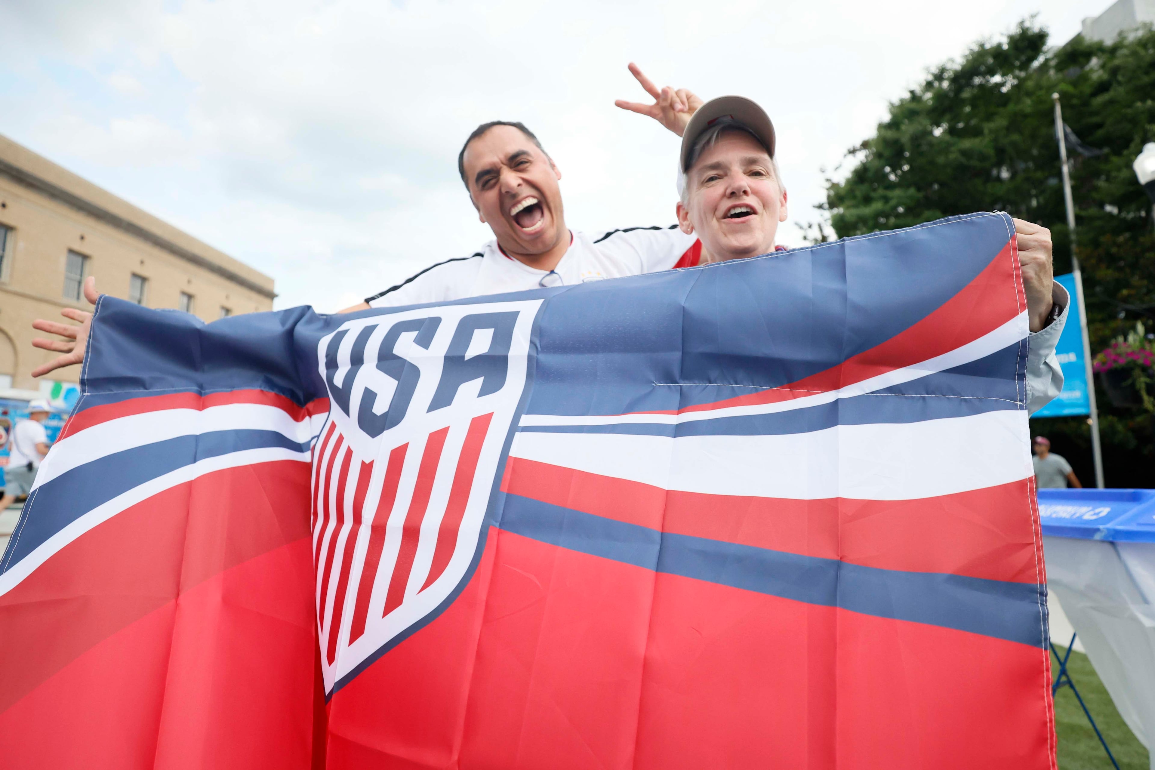 Atlanta neighbors Ozzie Arroyo and Gail Kirkland wave an American soccer team flag as they wait for the War and Treaty concert before watching the USA World Cup game during Decatur WatchFest ’26 on Thursday, June 25, 2026. (Miguel Martinez/AJC)