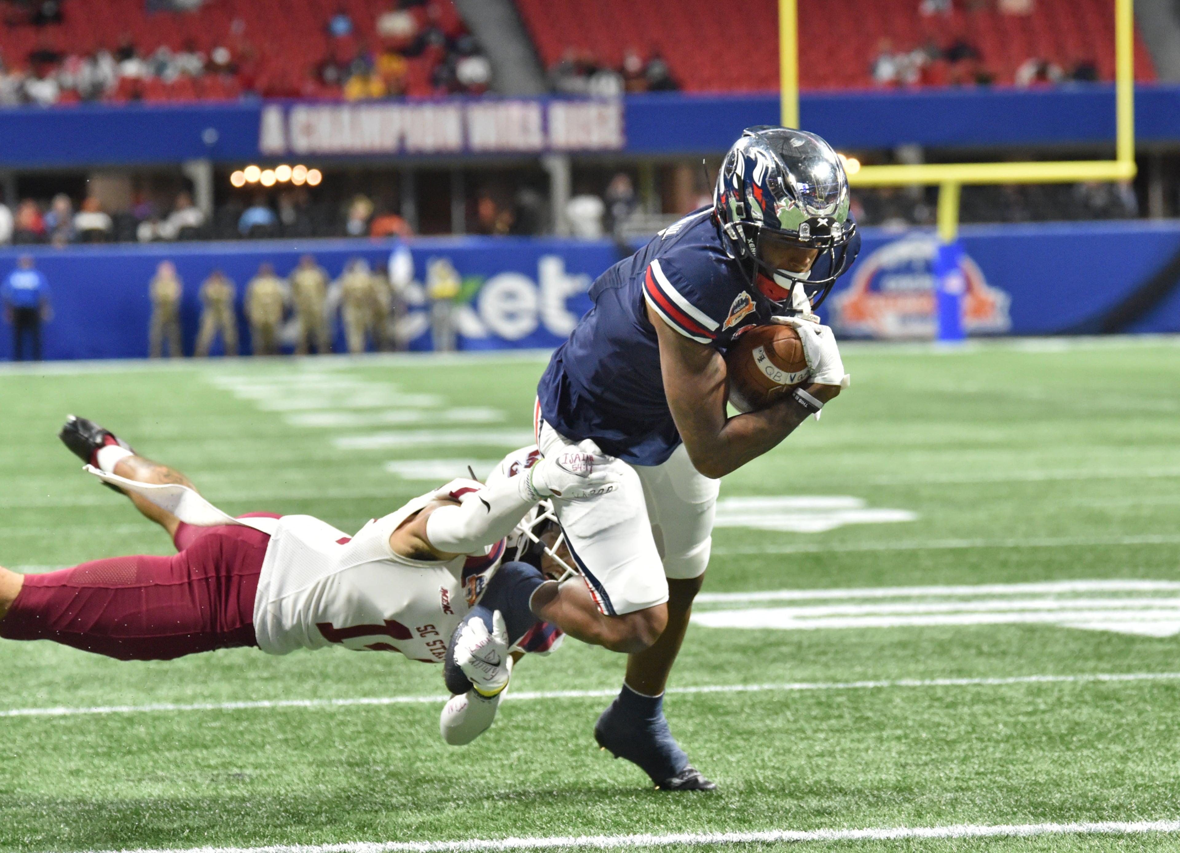 Jackson State's wide receiver Keith Corbin III (7) runs toward the end zone past South Carolina State's defensive back Decobie Durant (14) for a touchdown during the first half of the 2021 Cricket Celebration Bowl at Mercedes-Benz Stadium in Atlanta on Saturday, December 18, 2021. (Hyosub Shin / Hyosub.Shin@ajc.com)