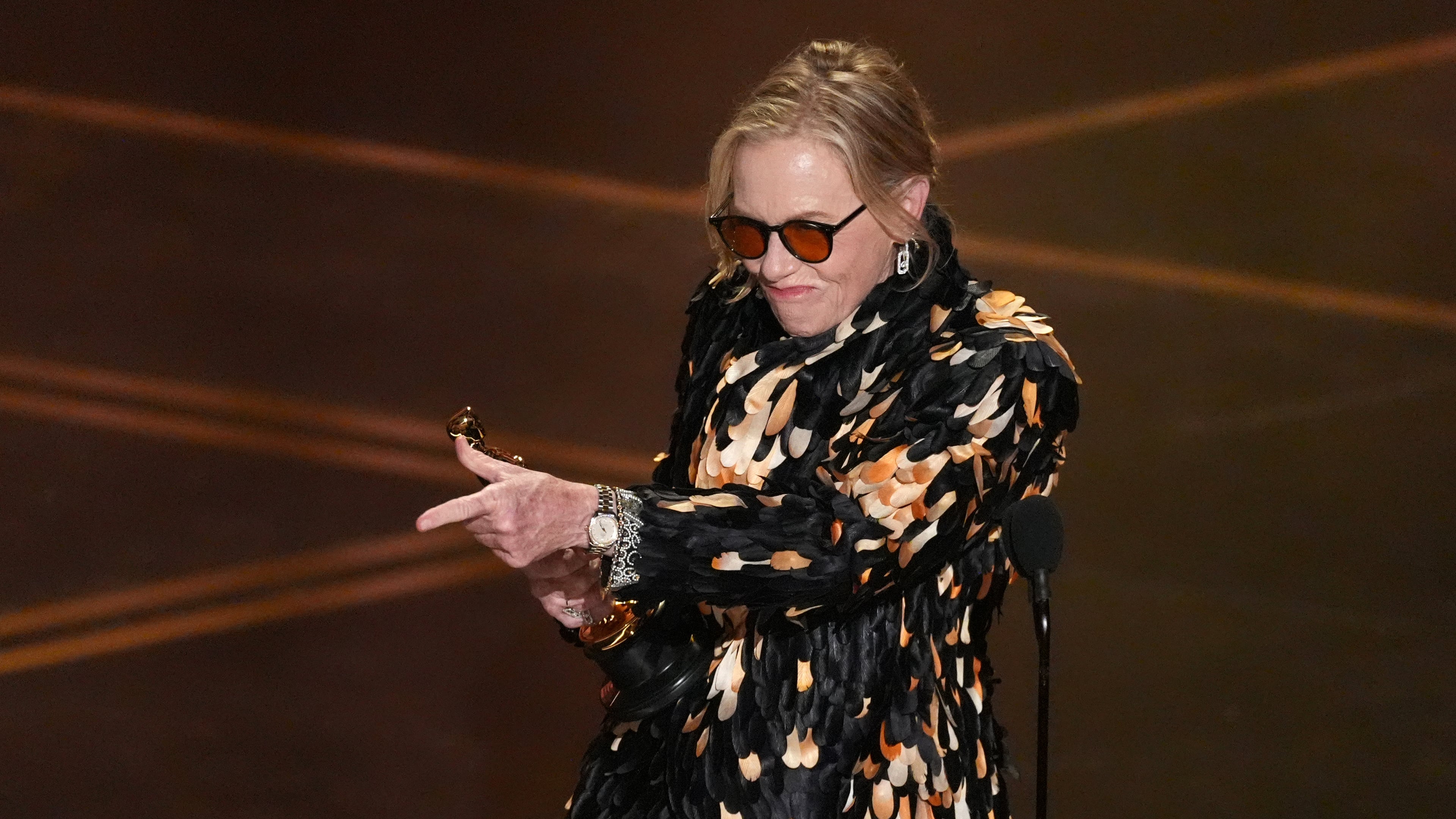 Amy Madigan accepts the award for actress in a supporting role for "Weapons" during the Oscars on Sunday, March 15, 2026, at the Dolby Theatre in Los Angeles. (AP Photo/Chris Pizzello)