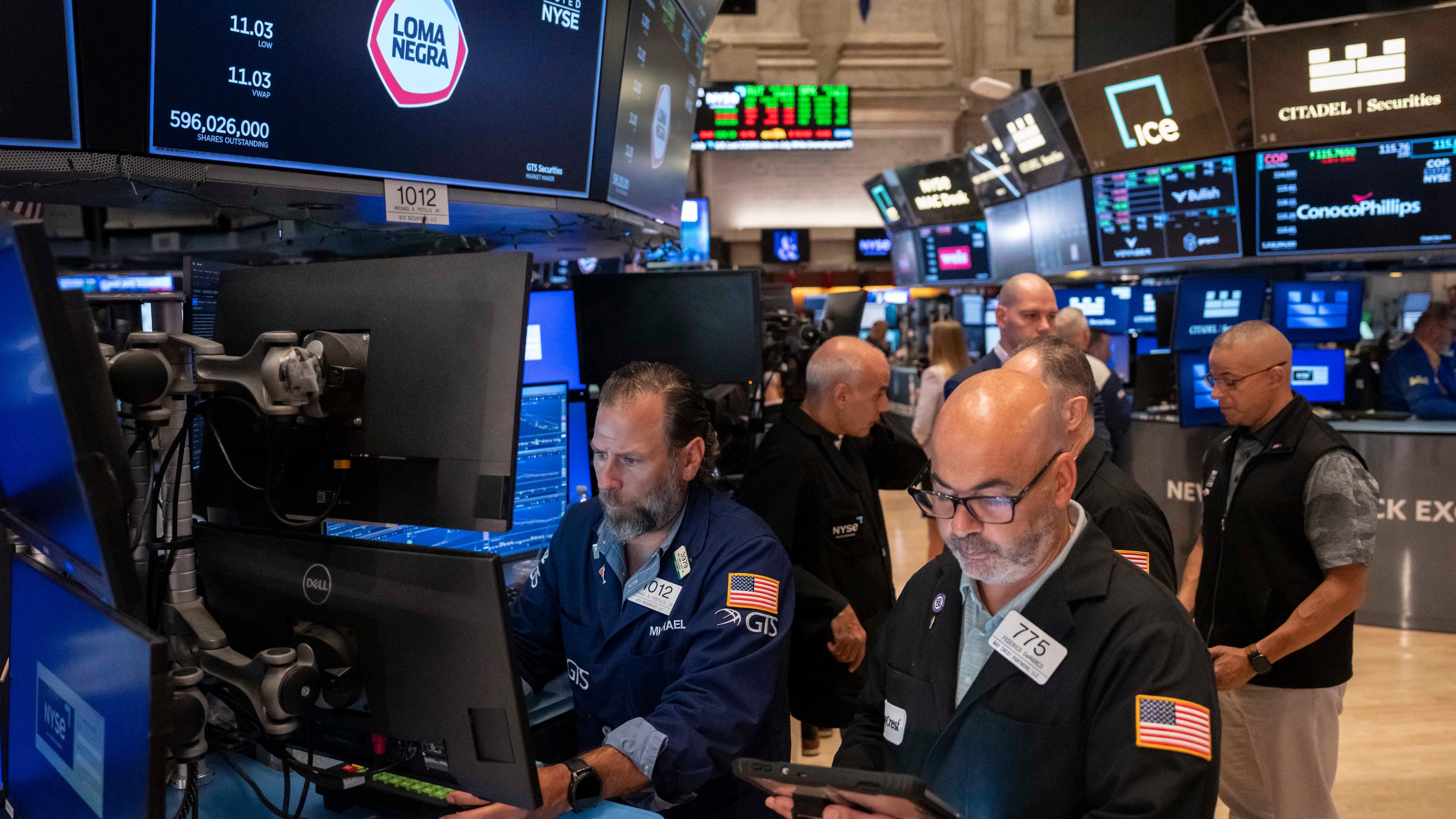 Trader Fred Demarco, right, and Specialist Michael Pistillo, left, work on the floor of the New York Stock Exchange, Friday, Aug. 7, 2026, in New York. (AP Photo/Yuki Iwamura)