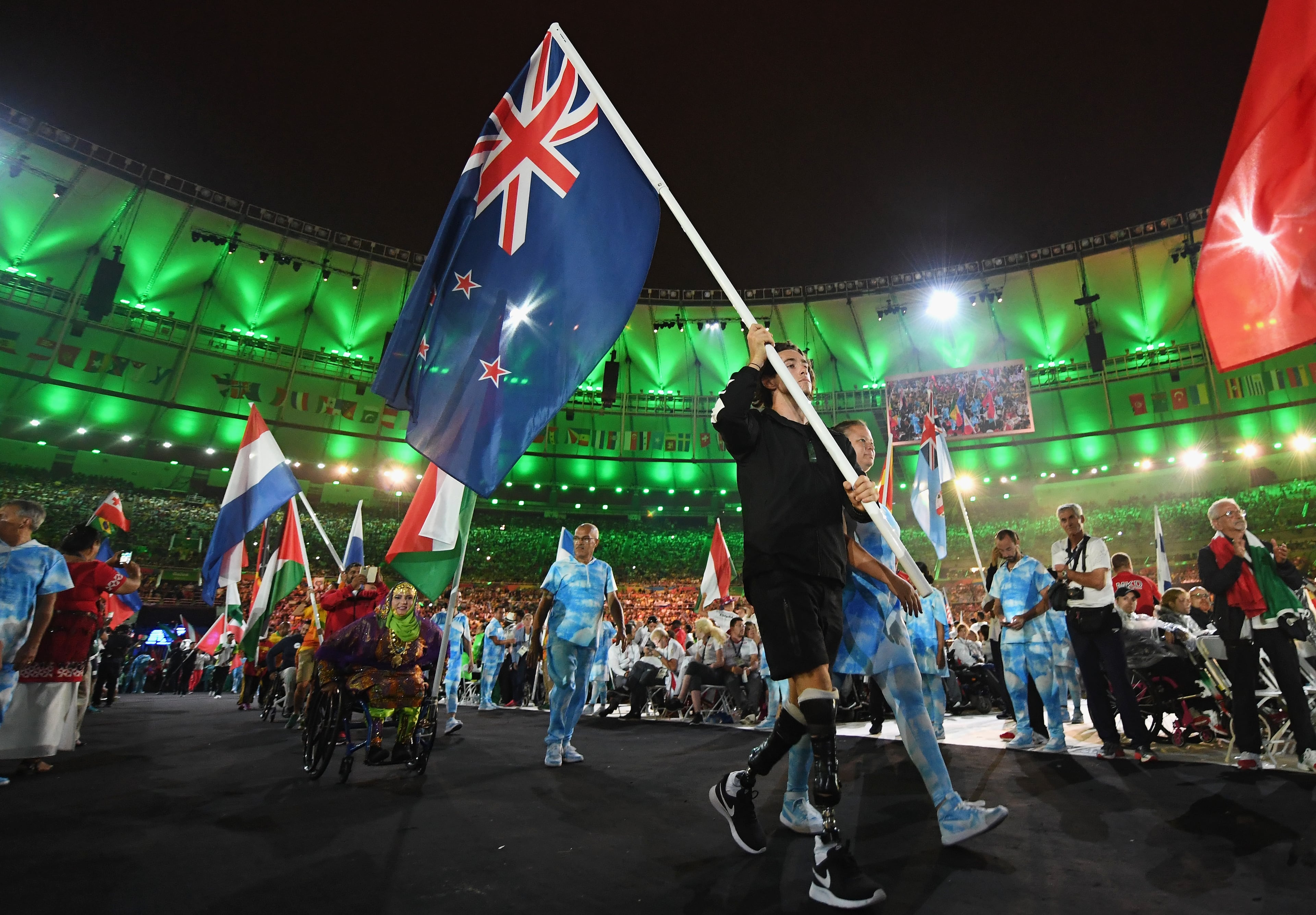 RIO DE JANEIRO, BRAZIL - SEPTEMBER 18: Gold and silver medalist Liam Malone carries the New Zealand flag during the closing ceremony of the Rio 2016 Paralympic Games at Maracana Stadium on September 18, 2016 in Rio de Janeiro, Brazil. (Photo by Atsushi Tomura/Getty Images for Tokyo 2020)