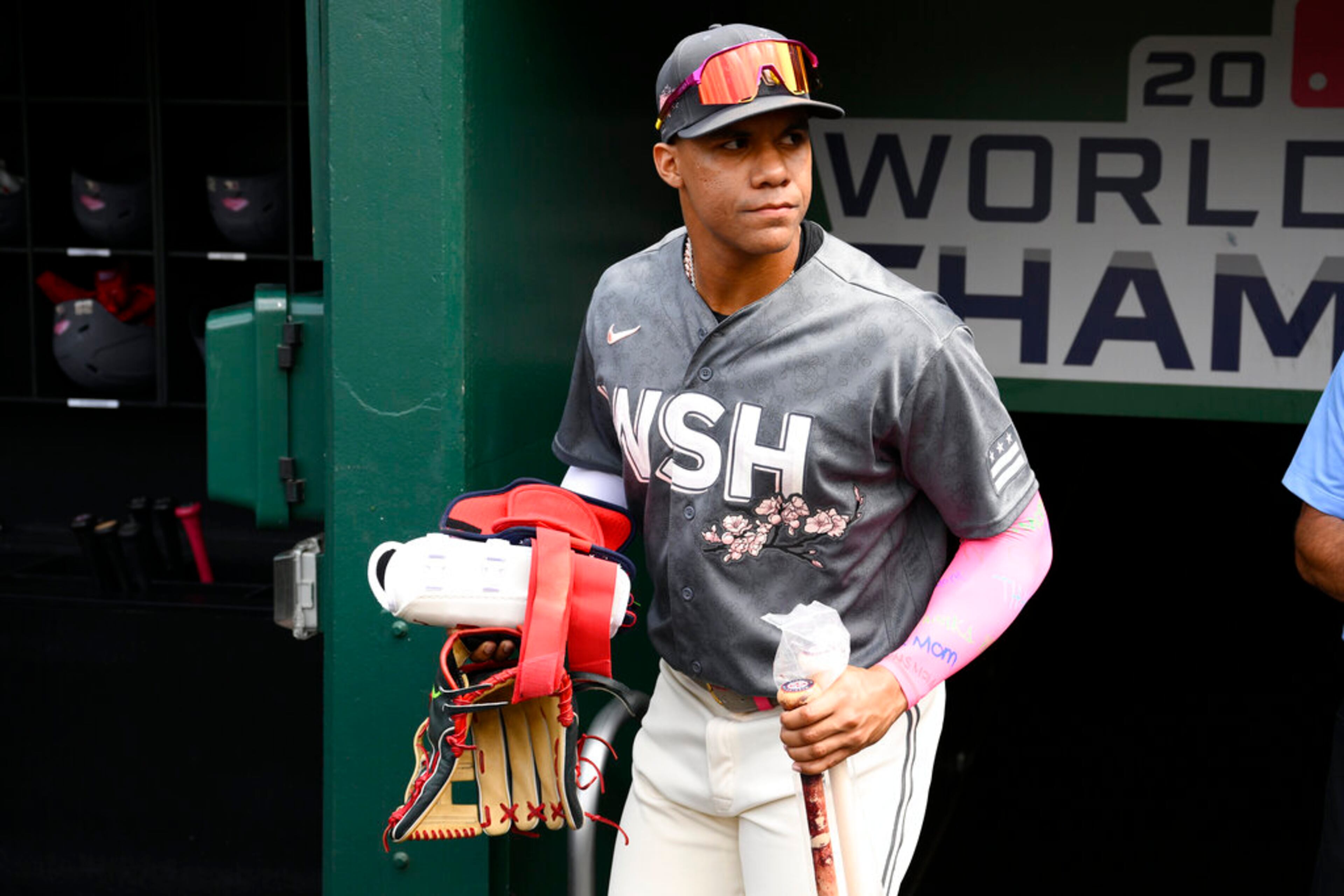 Washington Nationals' Juan Soto looks on from the dugout before a baseball game against the Atlanta Braves, Saturday, July 16, 2022, in Washington. (AP Photo/Nick Wass)