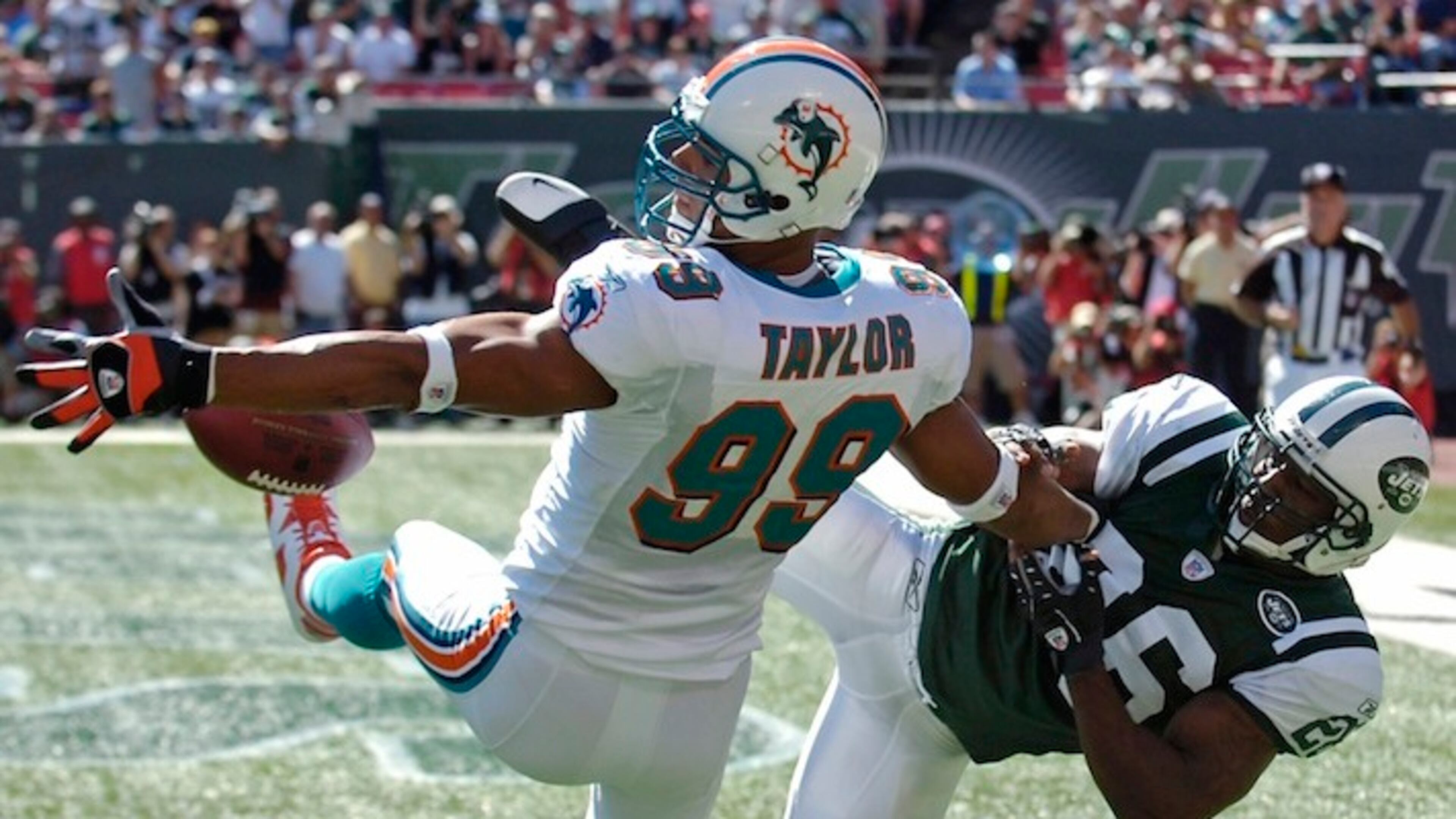 New York Jets Erik Coleman, right, breaks up a pass intended for Miami Dolphins defensive end Jason Taylor during second-quarter NFL football Sunday, Sept. 23, 2007, at Giants Stadium in East Rutherford, N.J. Coleman was penalized for pass interference. (AP Photo/Bill Kostroun)