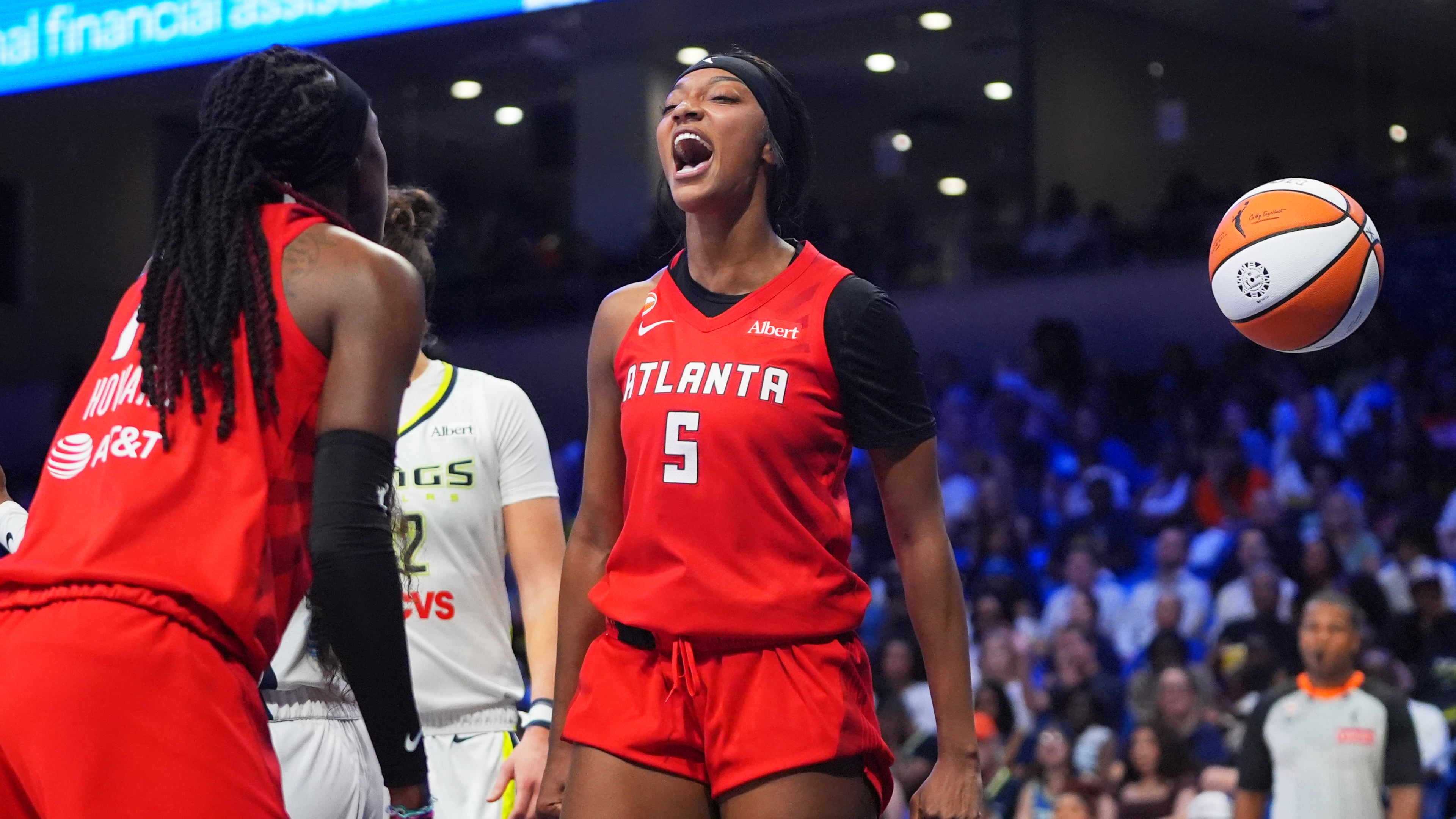 Atlanta Dream forward Angel Reese (5) reacts to scoring with teammate Rhyne Howard (10) during the second half of a WNBA basketball game against the Dallas Wings in Arlington, Texas, Wednesday, July 29, 2026. (LM Otero/AP)