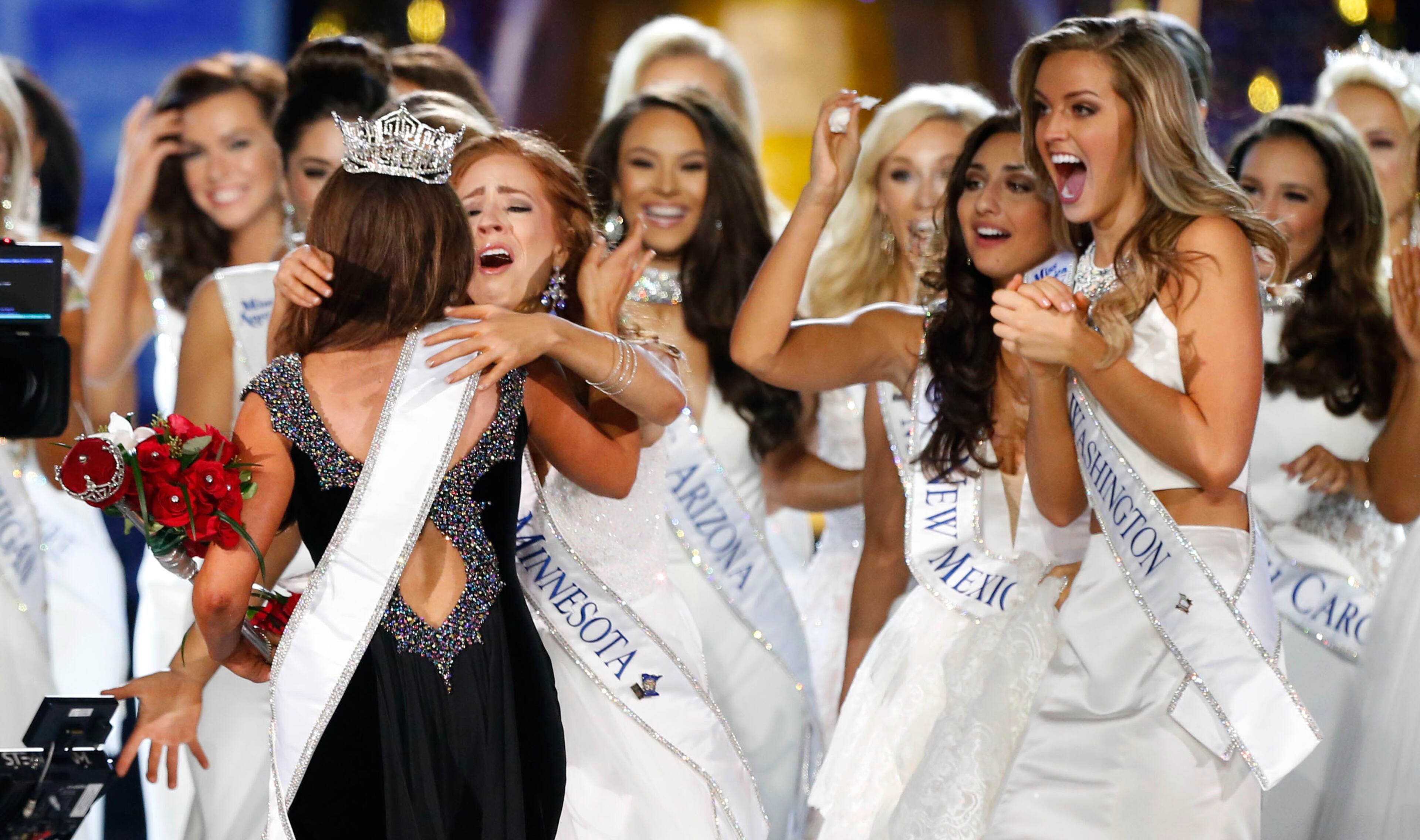 Miss North Dakota Cara Mund is congratulated by contestants after being named Miss America during Miss America 2018 pageant, Sunday, Sept. 10, 2017, in Atlantic City, N.J. (AP Photo/Noah K. Murray)