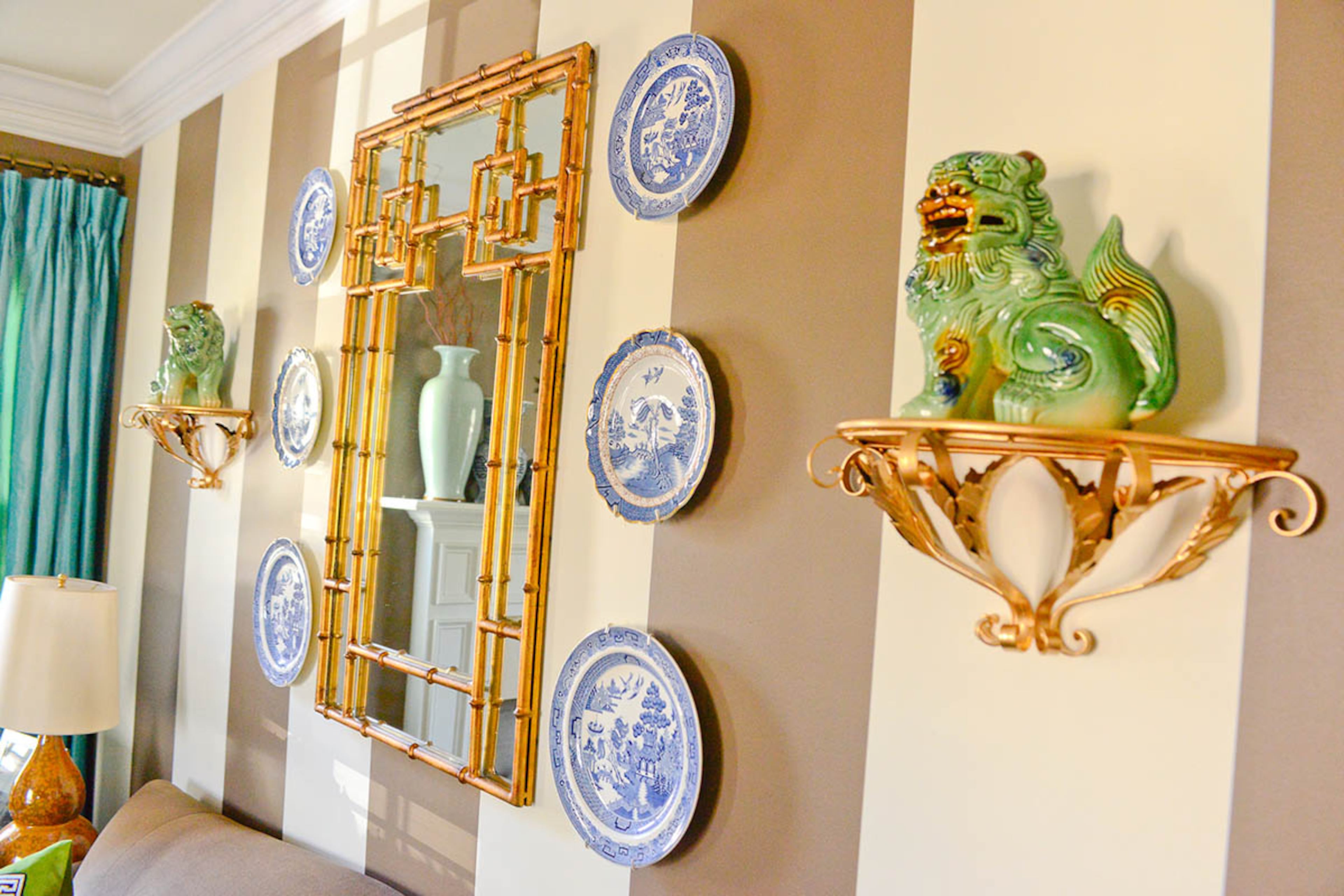 Foo dog sculptures bring hints of Greenery (the Pantone color of the year) into the living room. Blue and white china, a favorite of homeowner Katie Luepke, is also on display.