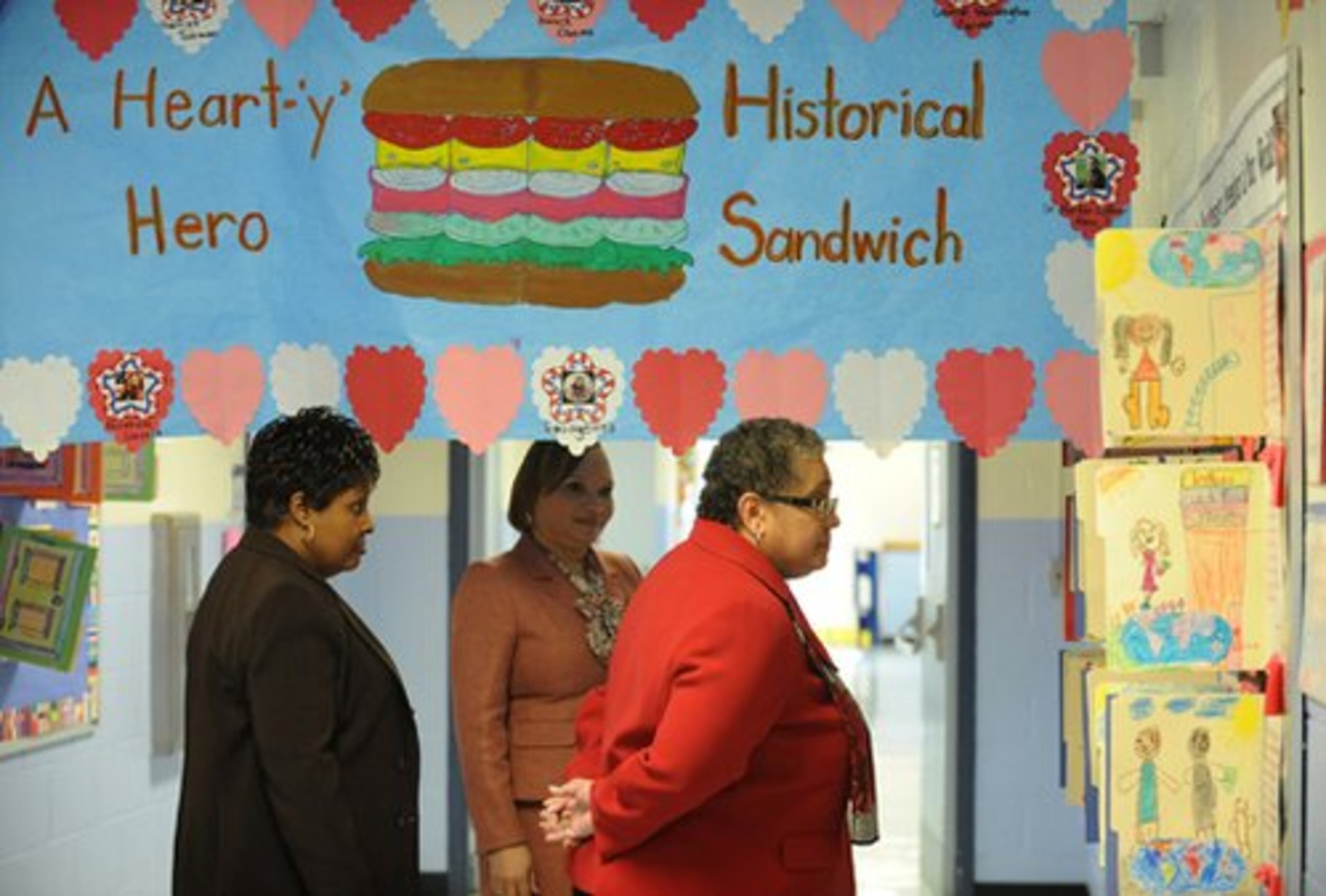 Beverly Hall (right) looks at some crafts that have done by Beecher Hills Elementary students, as Joyce McCloud (left), Special Assistant to the Superintendent, and Principal Robin Hall (center), look on.