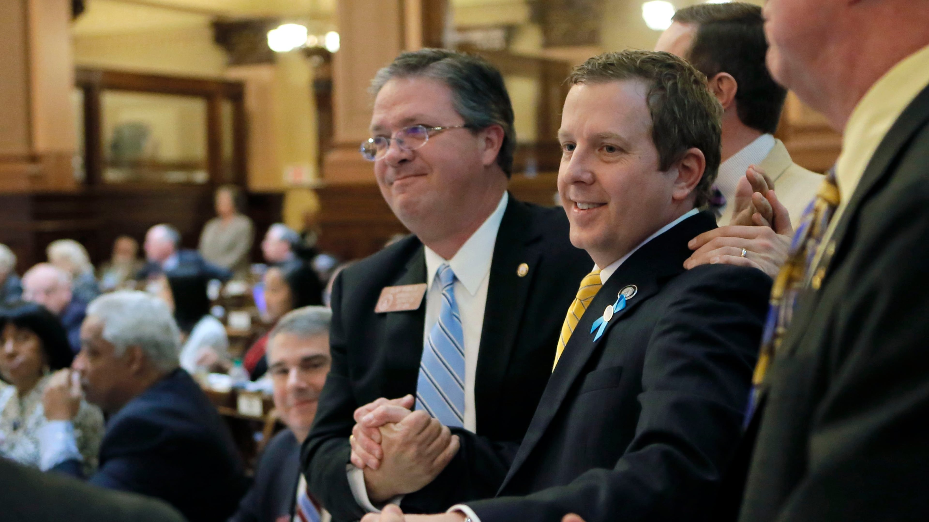 State Rep. Bert Reeves, R-Marietta, is congratulated after the passage of an adoption bill compromise in the House. The Senate has delayed action on the measure. BOB ANDRES /BANDRES@AJC.COM