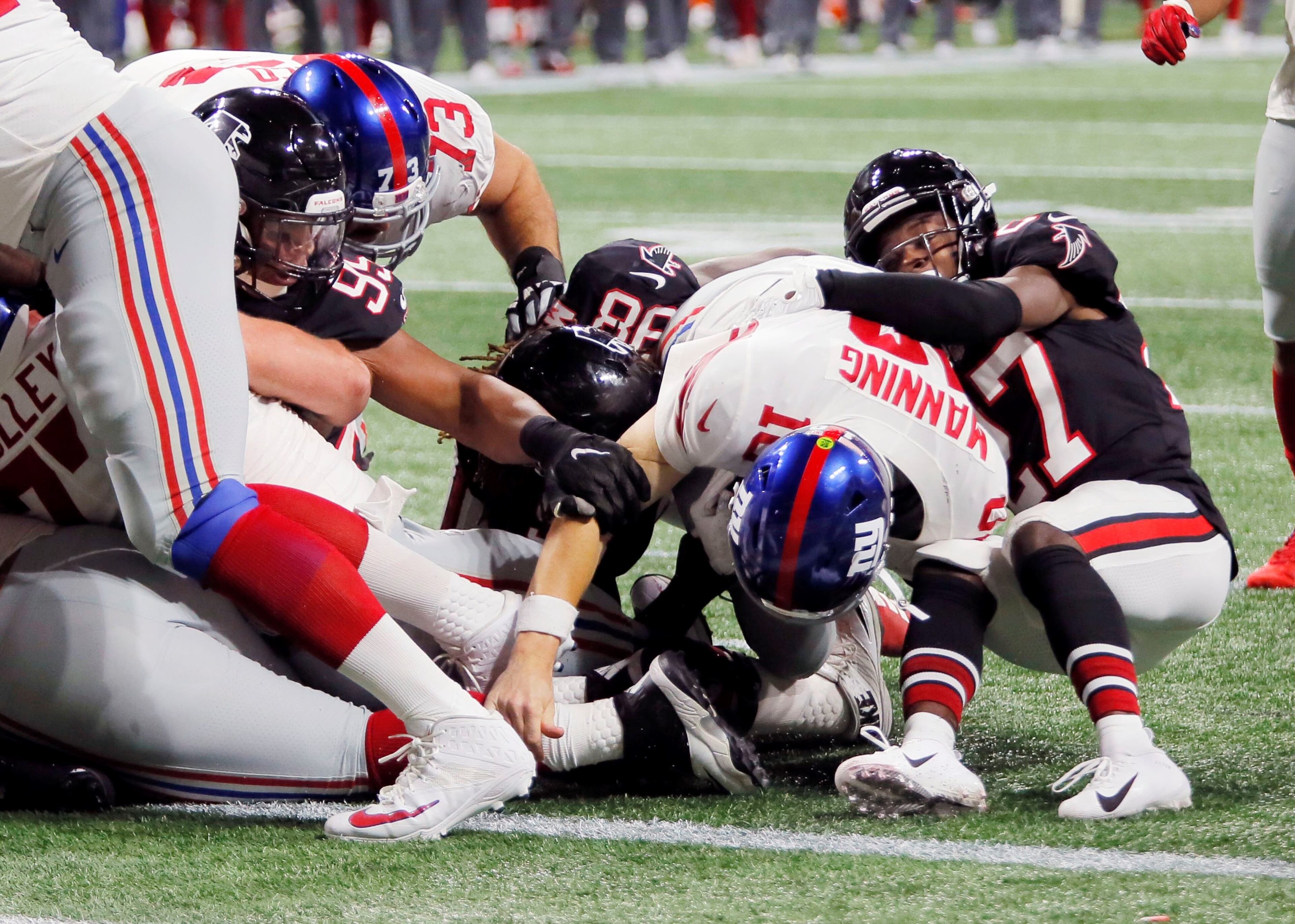 10/22/18 - Atlanta - Falcons defenders, including Atlanta Falcons defensive end Jack Crawford (95), and Atlanta Falcons strong safety Damontae Kazee (27), keep New York Giants quarterback Eli Manning (10) out of the end zone on successive quarterback keepers in the fourth quarter. The Atlanta Falcons played the New York Giants in an NFL football game Monday, October 22, 2018, at Mercedes-Benz Stadium in Atlanta, GA. BOB ANDRES / BANDRES@AJC.COM