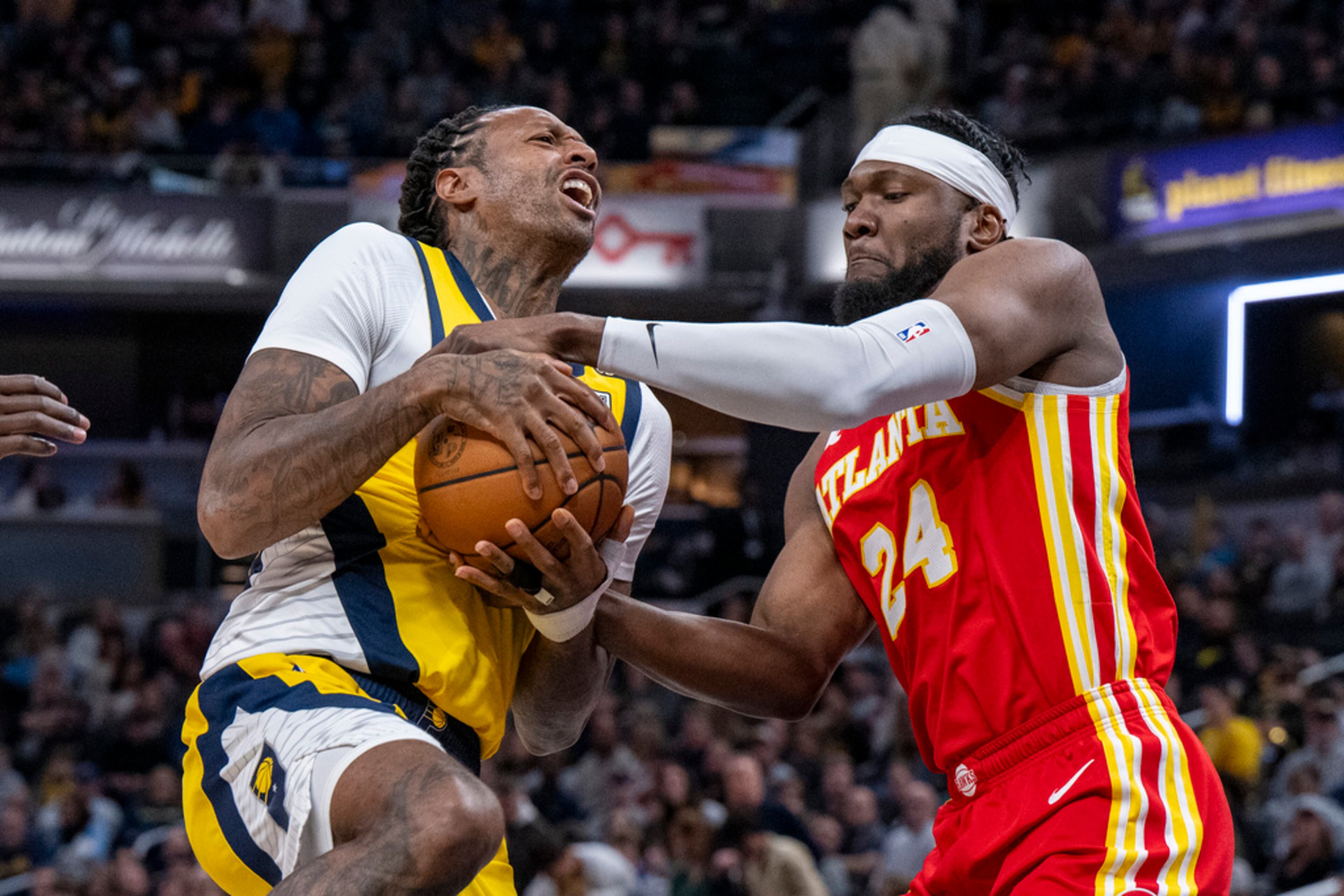 Atlanta Hawks forward Bruno Fernando (24) attempts to steal the ball from Indiana Pacers forward James Johnson during the second half of an NBA basketball game in Indianapolis, Friday, Jan. 5, 2024. (AP Photo/Doug McSchooler)