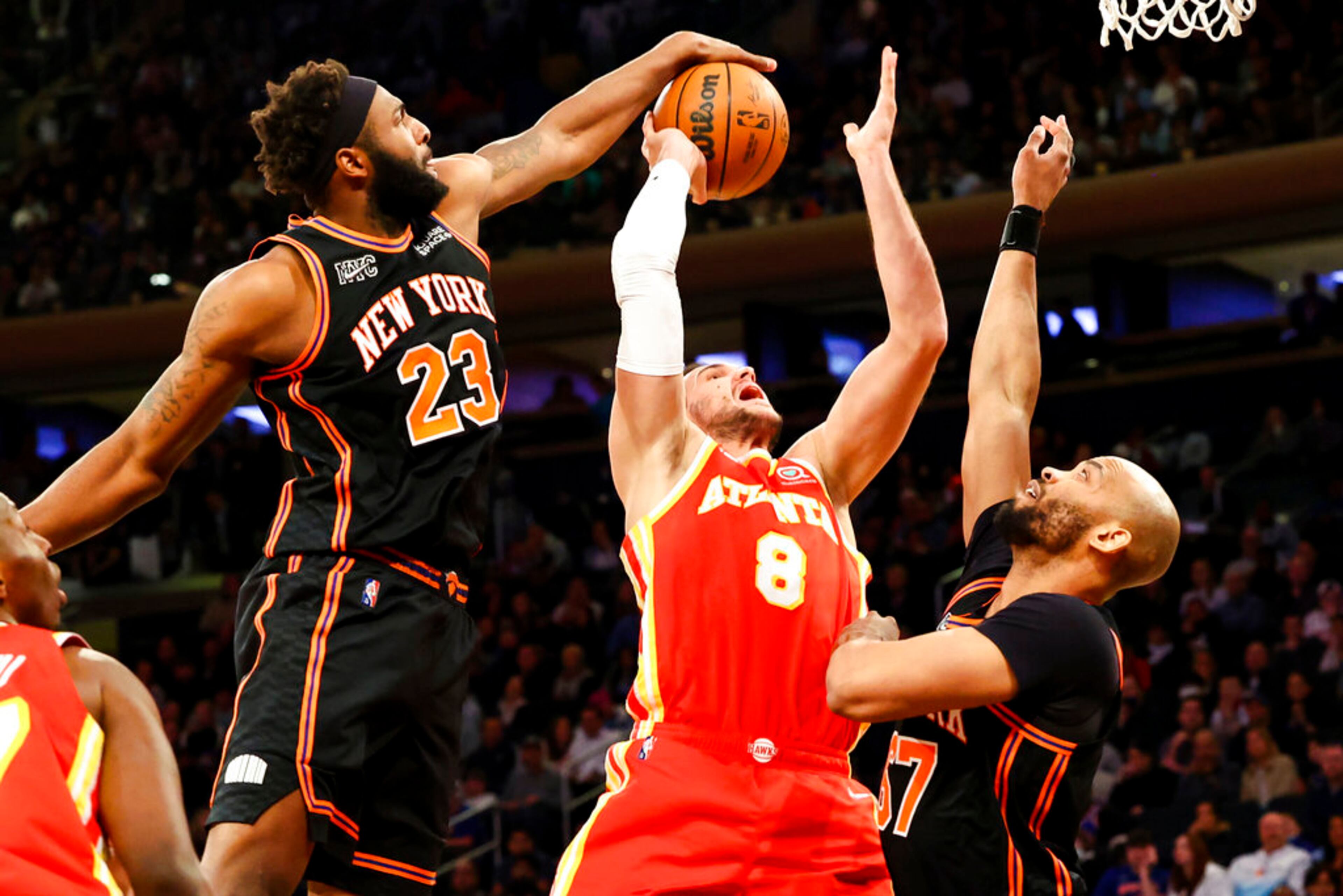 New York Knicks center Mitchell Robinson (23) blocks a shot by Atlanta Hawks forward Danilo Gallinari (8) during the first half of an NBA basketball game, Tuesday, March 22, 2022, in New York. (AP Photo/Jessie Alcheh)