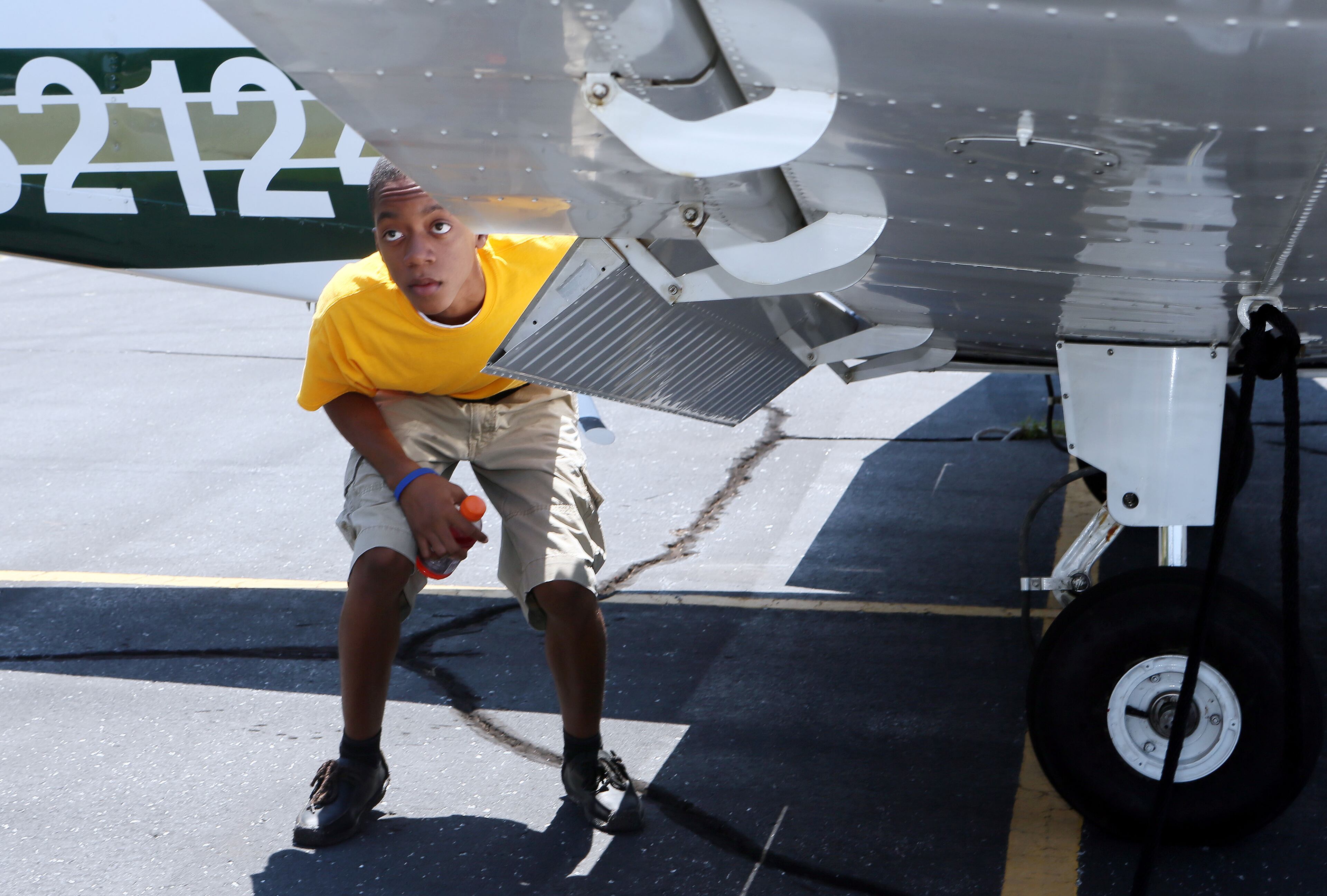JULY 25, 2013-PEACHTREE CITY: Khayton Morley with the Aviation Career Enrichment/Organization of Black Aerospace Professions summer program listened to Don Tagle's preflight instructions before they embarked on a "discover flight" from Atlanta Regional Airport Falcon Field in Peachtree City on Thursday July 25th, 2013. Teens were selected out of hundreds of applicants for the nationwide program to give them flight experience with instructors. With a large number of pilots and others in the aerospace industry retiring in the next few years, aviation officials are looking to get young people involved in all aspects of flying. PHIL SKINNER / PSKINNER@AJC.COM editor's note: CQ