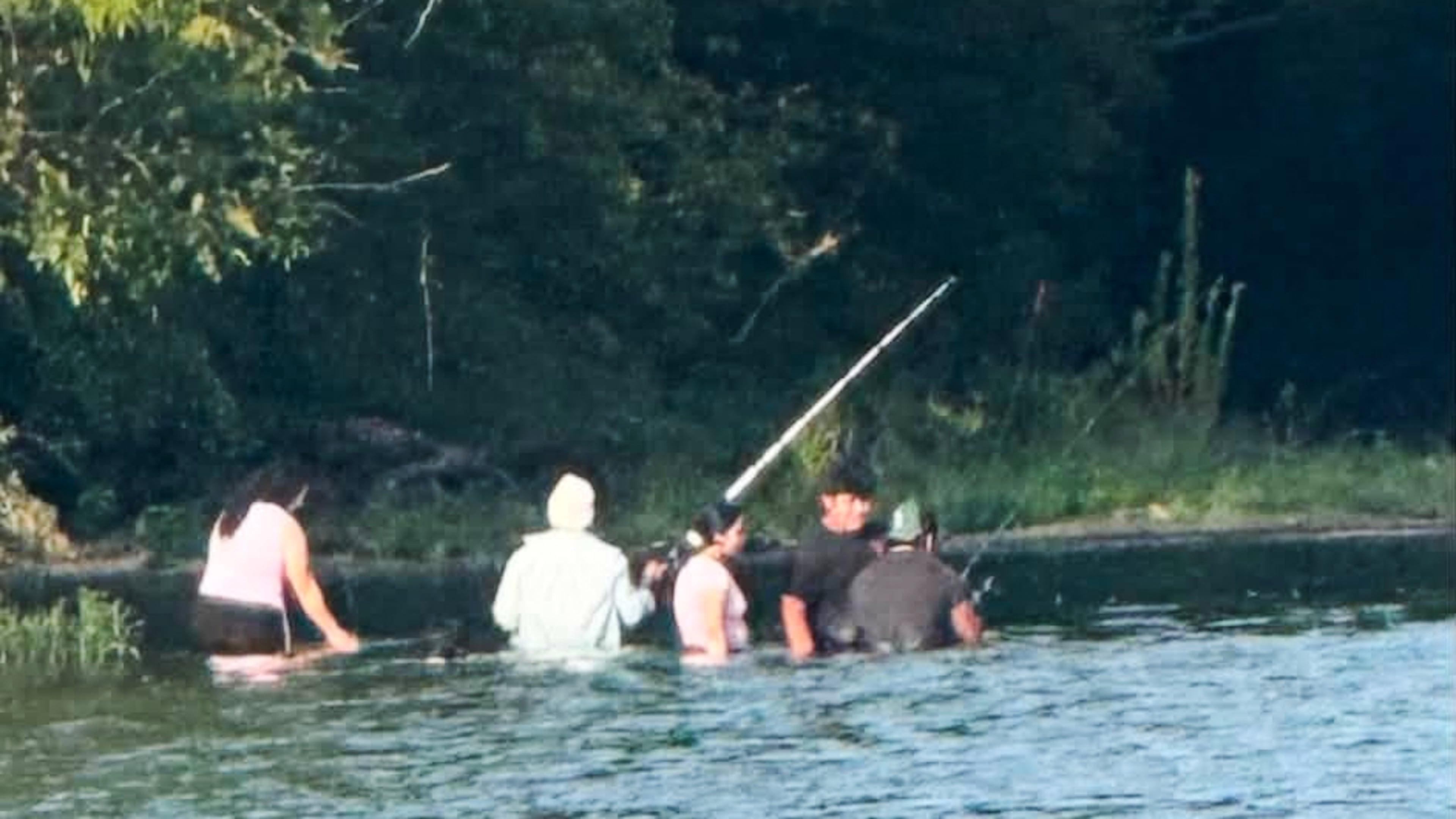 In this photo provided by Pastor Marcus L. Martin, a group of people he believes were those who died in a recent drowning accident, are shown fishing along the Scioto river in Powell, Ohio, Sunday, July 19, 2026. (Pastor Marcus L. Martin via AP)
