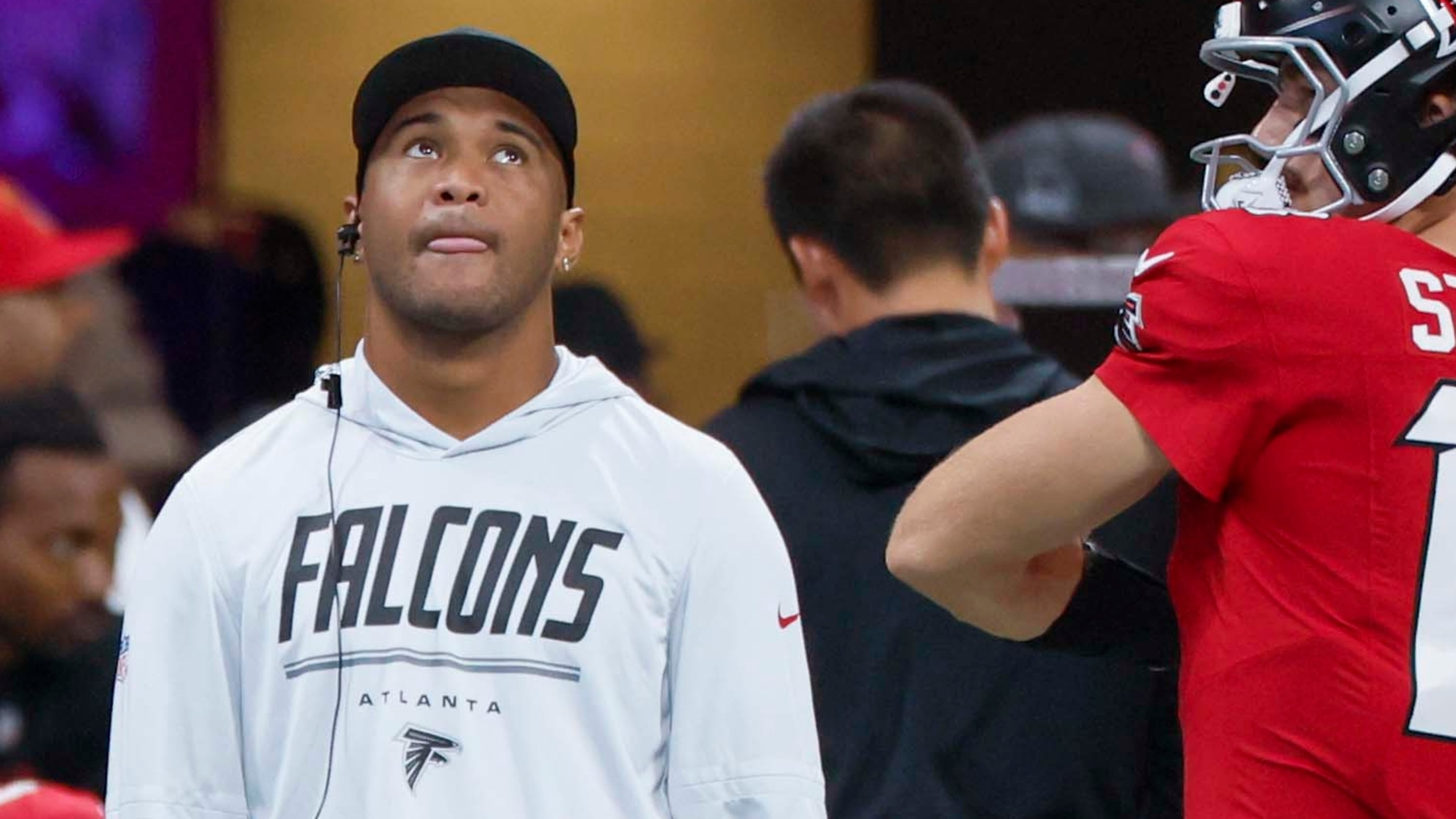 Falcons quarterback Tua Tagovailoa watches from the sidelines as his team faces the Carolina Panthers at Mercedes-Benz Stadium on Sunday, Sept. 20, 2026, in Atlanta. The Falcons expect the 28-year-old to be a positive contributor in whatever capacity his health, and opportunity, provides. (Miguel Martinez/AJC)