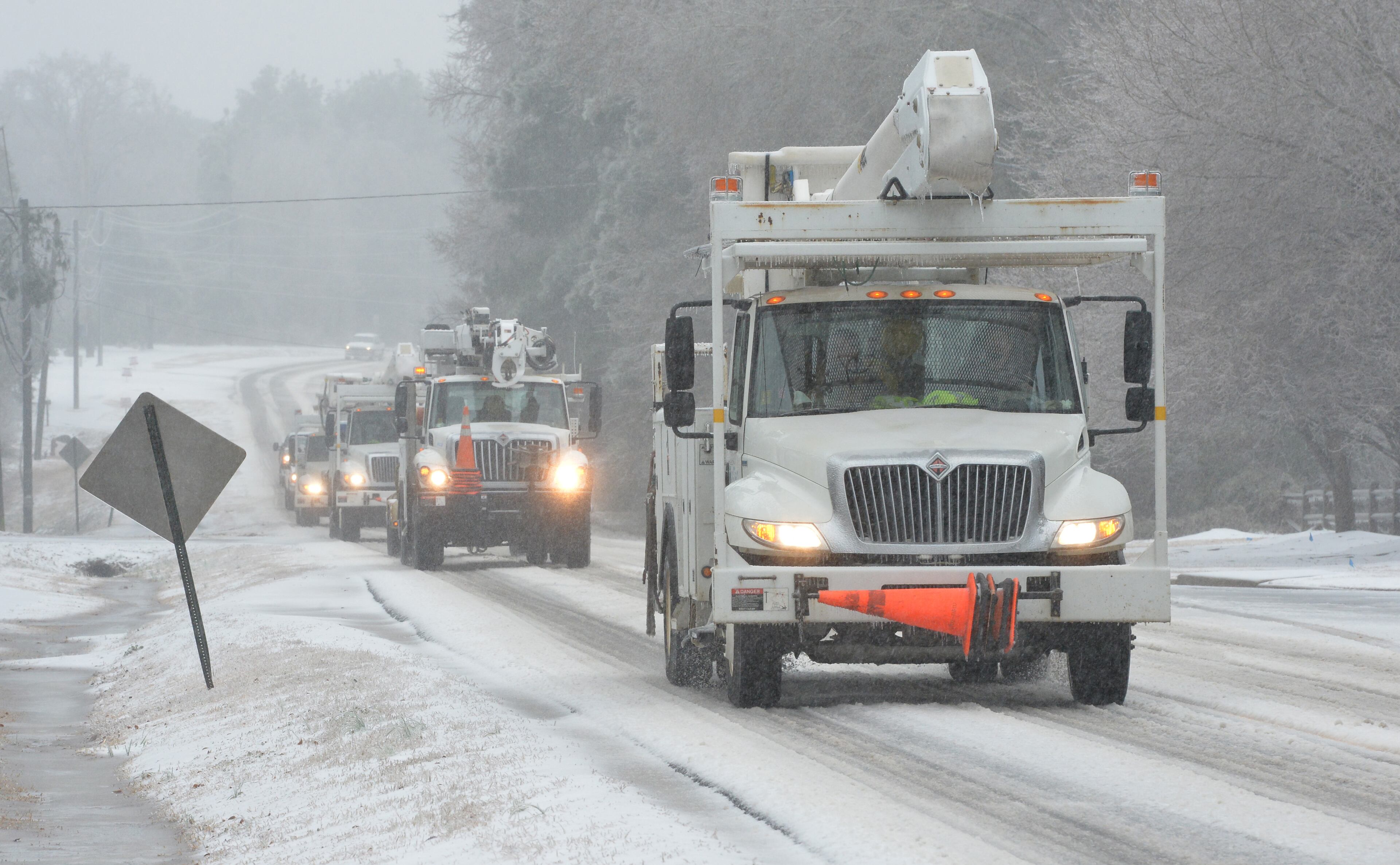Utility trucks make their way in Martinez, suburb of Augusta on Wednesday, February 12, 2014. HYOSUB SHIN / HSHIN@AJC.COM