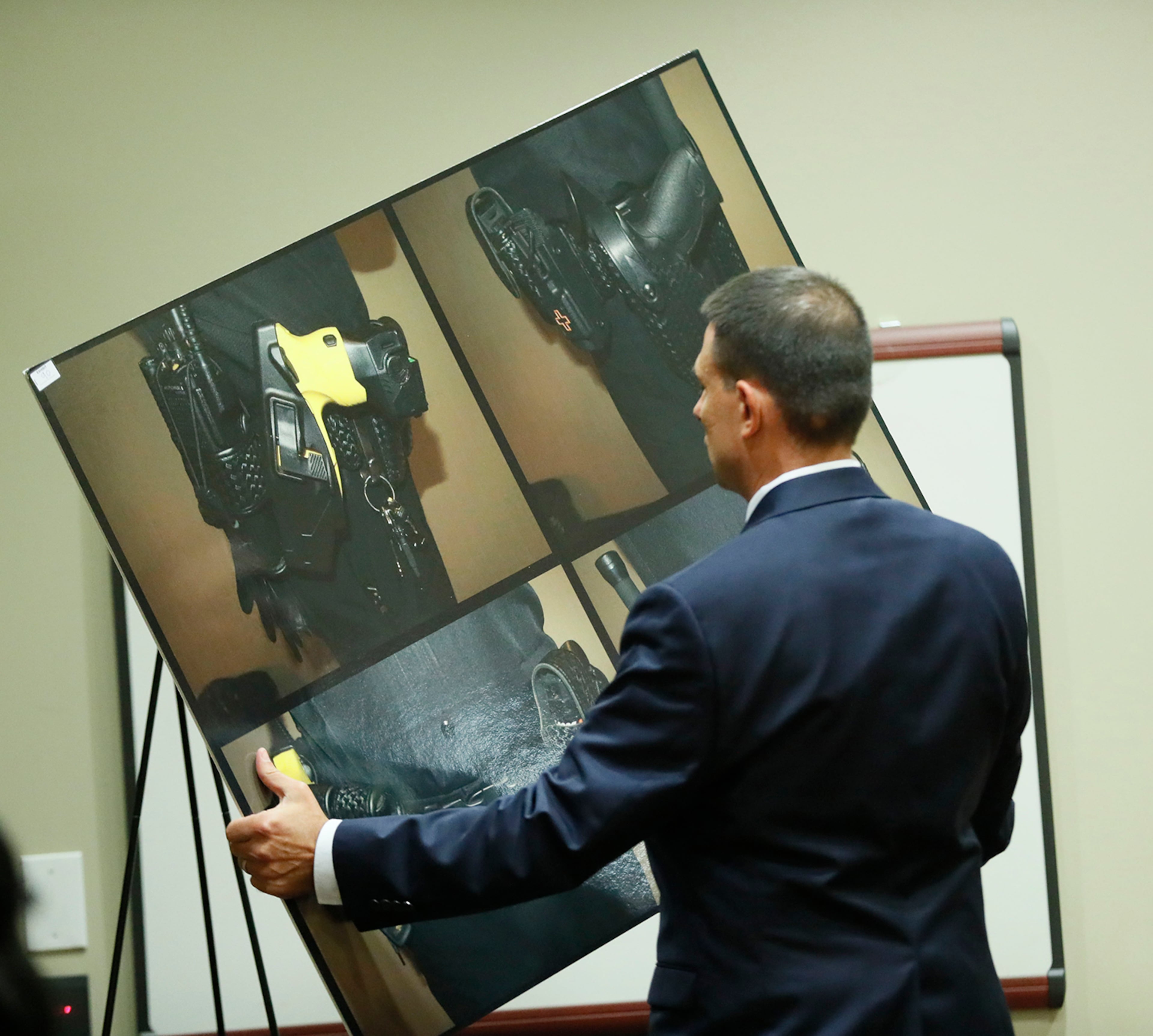 October 2, 2019 - Decatur - Prosecutor Pete Johnson sets up a photo display of the weapons available on Robert Olsen's belt, which included a taser, gun, O.C. spray and an expandable baton. The murder trial of former DeKalb County Police Officer Robert "Chip" Olsen continued today. Olsen is charged with murdering war veteran Anthony Hill. Bob Andres / robert.andres@ajc.com