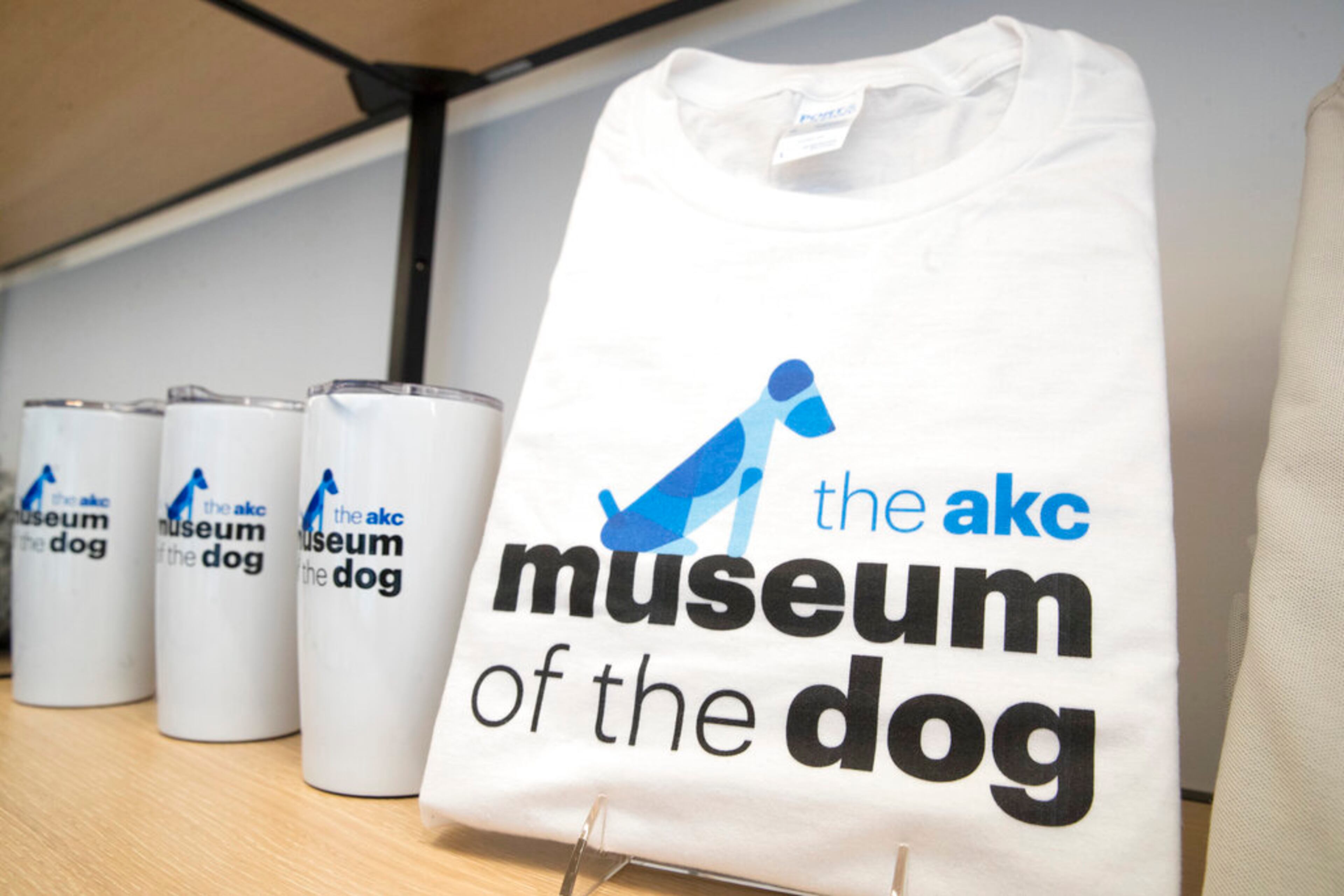 This Wednesday, Jan. 9, 2019, photo shows merchandise with the American Kennel Club Museum of the Dog's logo on display for sale at the museum store in New York. The museum opens Feb. 8. (AP Photo/Mary Altaffer)
